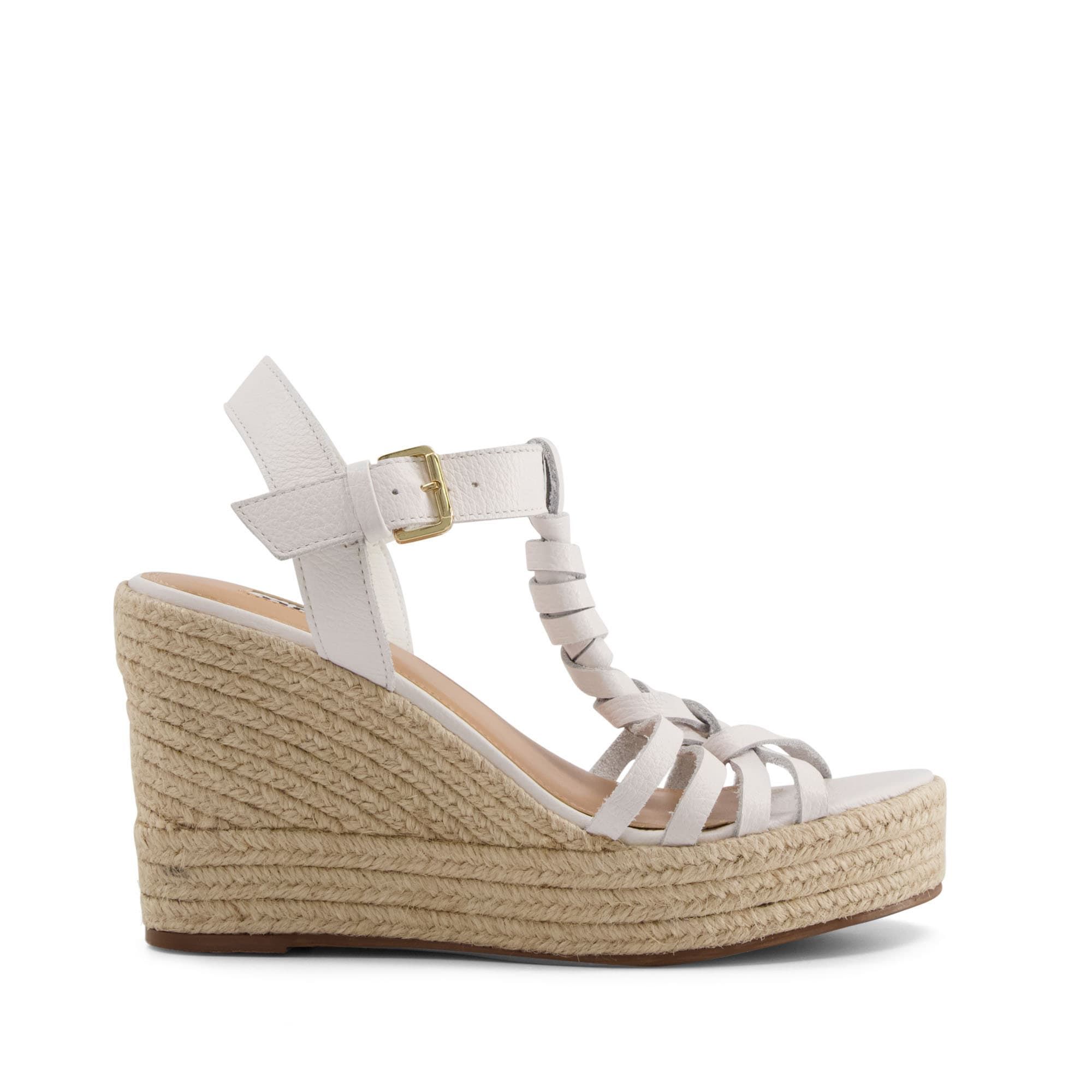 Reinvigorate your Summer wardrobe. The plaited leather twists on these sandals enhance the luxe artisan feel. They rest on natural raffia high wedges, grounded with rubber for grip.
