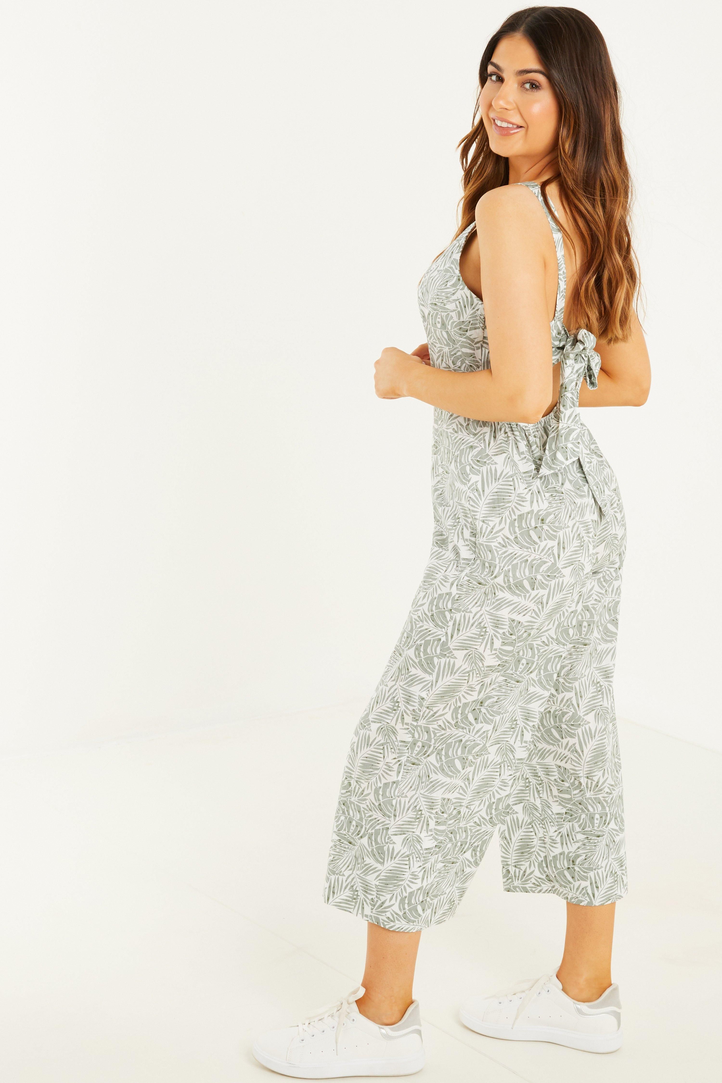 - Petite collection   - Tropical print  - Culotte style  - V neck   - Backless  - Tie back   - Length: 113 cm approx  - Model Height: 5' 3
