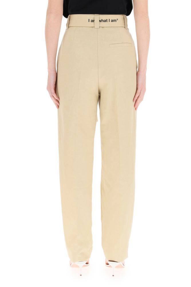 MGSG trousers in cotton and linen canvas featuring a wide-leg cut with front pleats and a slightly tapered hem. High waist highlighted by a removable matching belt with contrasting logo print on the edge. Front closure with concealed zip, side French pockets, rear welt pockets. The model is 177 cm tall and wears a size IT 38.