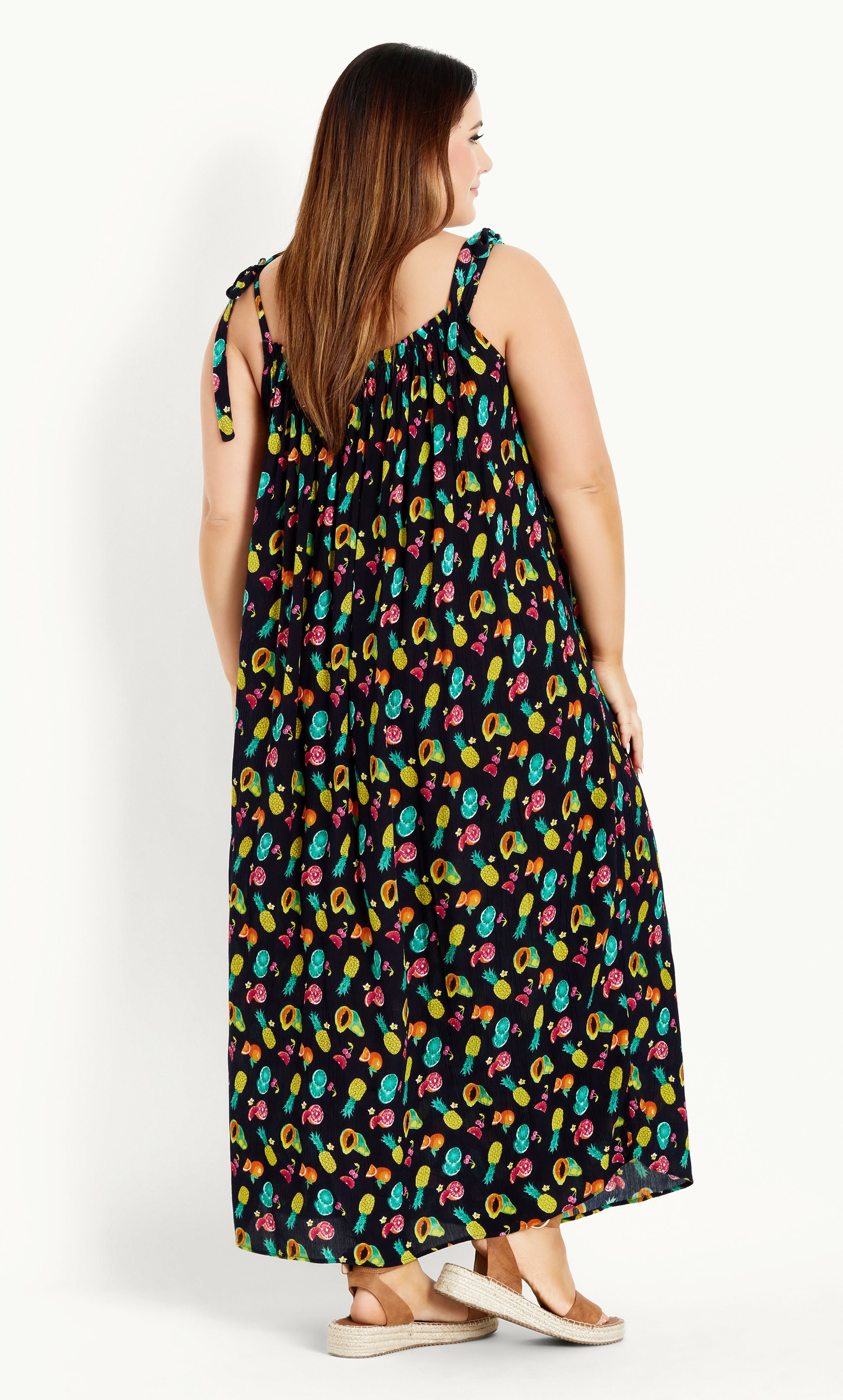 The Tie Shoulder Dress features a super cute fruit print and comfortable relaxed fit, perfect for soaking up the sunshine in style. Featuring tie shoulder straps for added feminine flair, this dress is a stylish pick for beachside strolls and picnic dates. Key Features Include: - Straight elasticated neckline - Self-tie shoulder straps - Textured non-stretch fabrication - Relaxed fit - Pull over style - Unlined - Maxi length Complete the look with strappy black sandals and an oversized straw hat.
