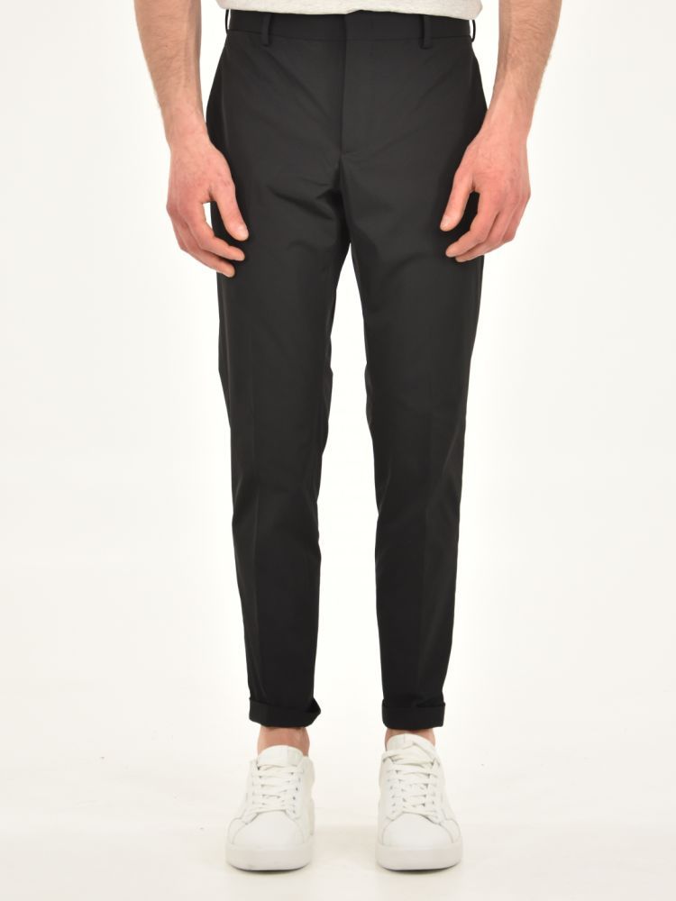 Black stretch fit nylon trousers with turn-up at the bottom. Side and back pockets, belt loops at the waist.The model is 183 cm tall and wears size M
