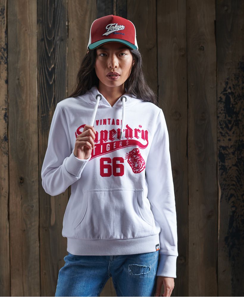 Update your hoodie collection with the Varsity Standard hoodie, featuring a collegiate varsity logo across the chest. Layer over a classic tee with jeans for extra warmth and comfort this season.Drawstring hoodFront pouch pocketRibbed cuffs and hemLoopback liningFlock Superdry graphicSignature logo tab