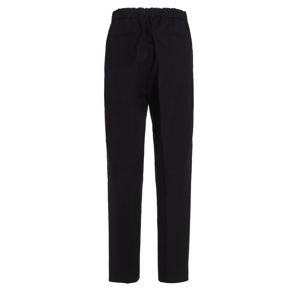 'Alem' cotton trousers with an elastic at the back and a zip and hook-and-hook closure.