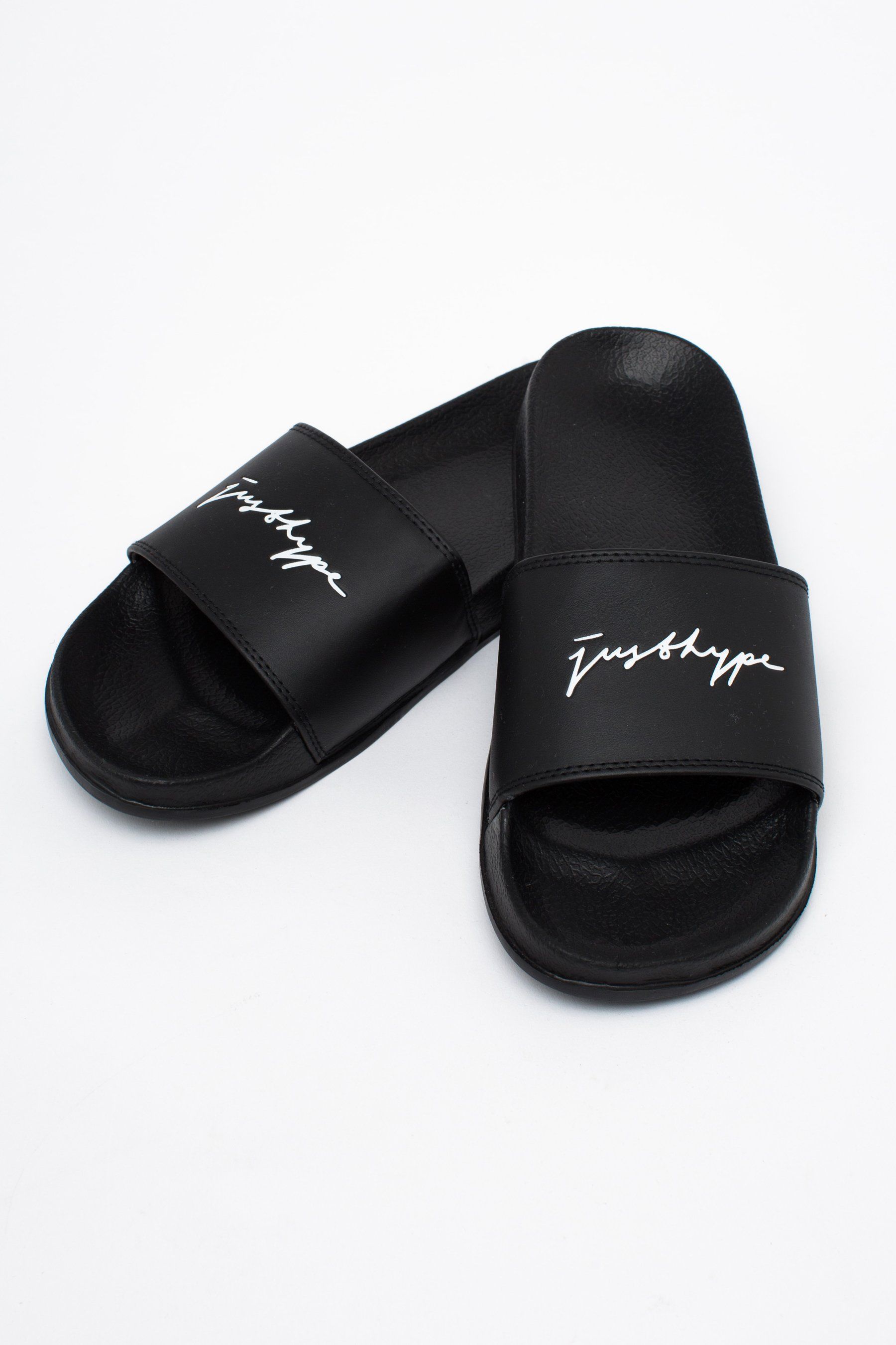 The ultimate footwear to take your comfort level from 0 - 100. The HYPE. men's black signature sliders feature a black base on the sole and crest. Designed in the upmost supreme amount of comfort finished with the just hype signature logo in a contrasting white. Wear around the pool with swim shorts or with a tracksuit set and ribbed crew socks for an off-duty style. Wipe clean only.