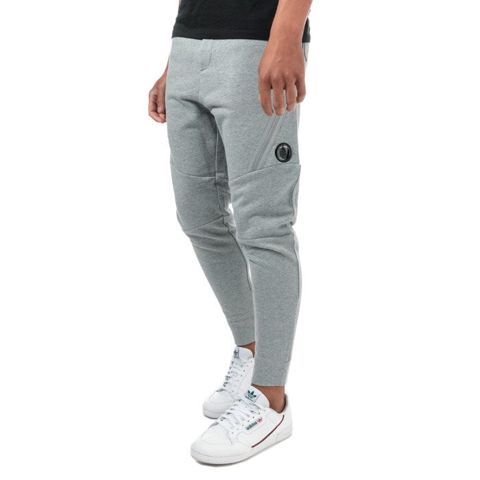 Mens C.P. Company Diagonal Fleece Jog Pants  Grey. <BR><BR>- Constructed from a soft cotton.<BR>- Relaxed and comfortable fit. <BR>- Tapered ankle. <BR>- Elasticated waistband for a precise fit. <BR>- Symmetrical side pockets & large zip pockets. <BR>- Iconic Lens detailing for brand recognition on right front leg.<BR>- 100% cotton. Machine washable.<BR>- Ref: 09CMSP029AM93