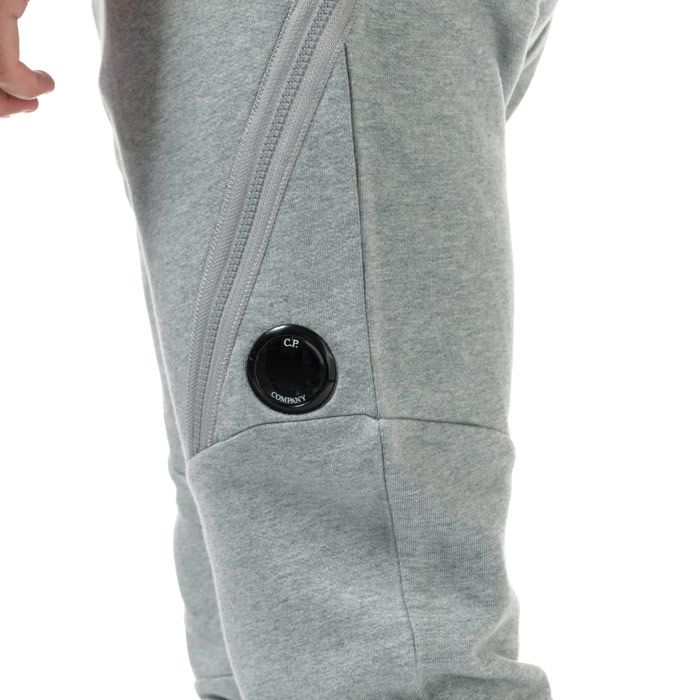 Mens C.P. Company Diagonal Fleece Jog Pants  Grey. <BR><BR>- Constructed from a soft cotton.<BR>- Relaxed and comfortable fit. <BR>- Tapered ankle. <BR>- Elasticated waistband for a precise fit. <BR>- Symmetrical side pockets & large zip pockets. <BR>- Iconic Lens detailing for brand recognition on right front leg.<BR>- 100% cotton. Machine washable.<BR>- Ref: 09CMSP029AM93