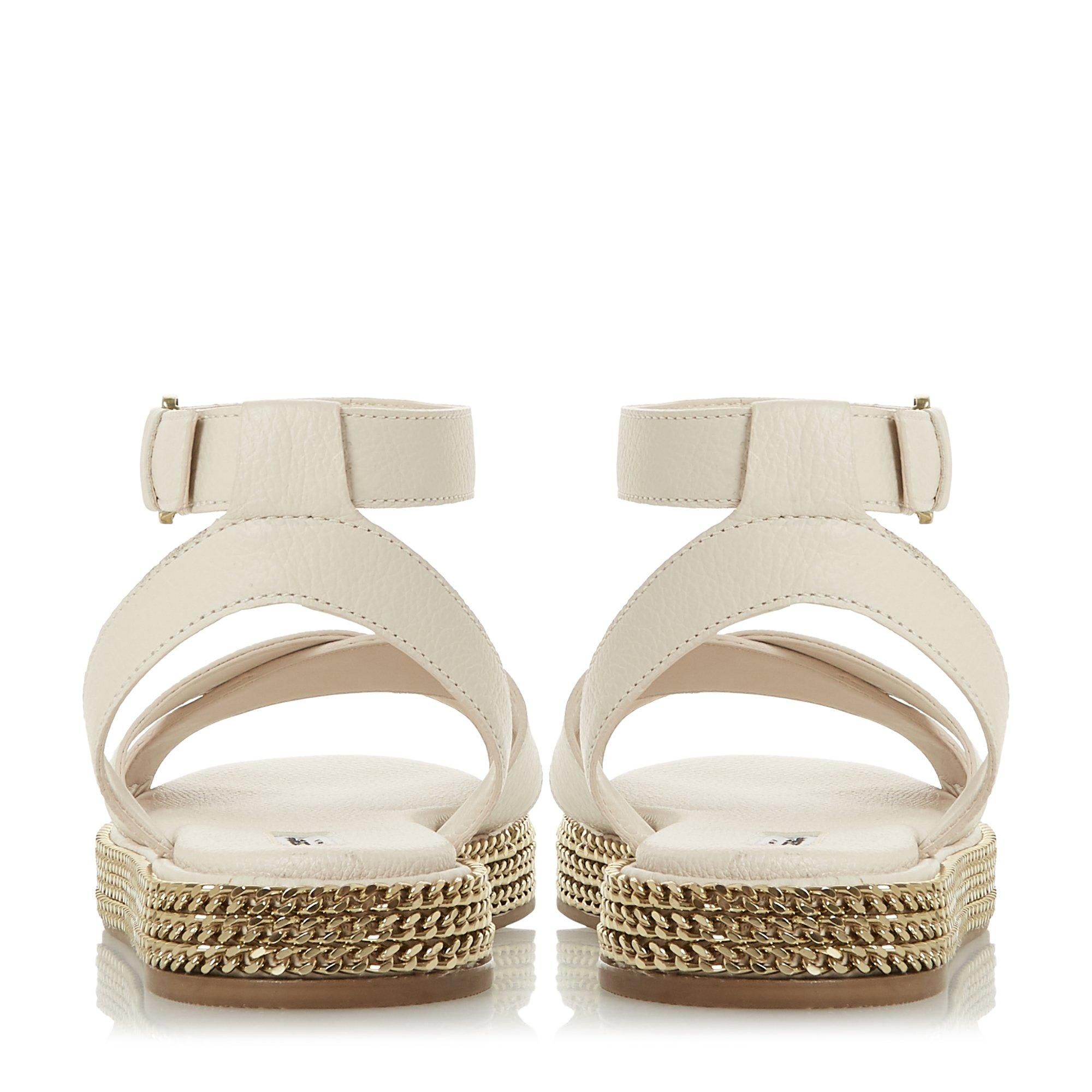 Toughen up summer and holiday edits with this sandal. Fitted with a buckled ankle strap and crossed bands at the upper. Its comfortable chunky sole is embellished with striking chains.