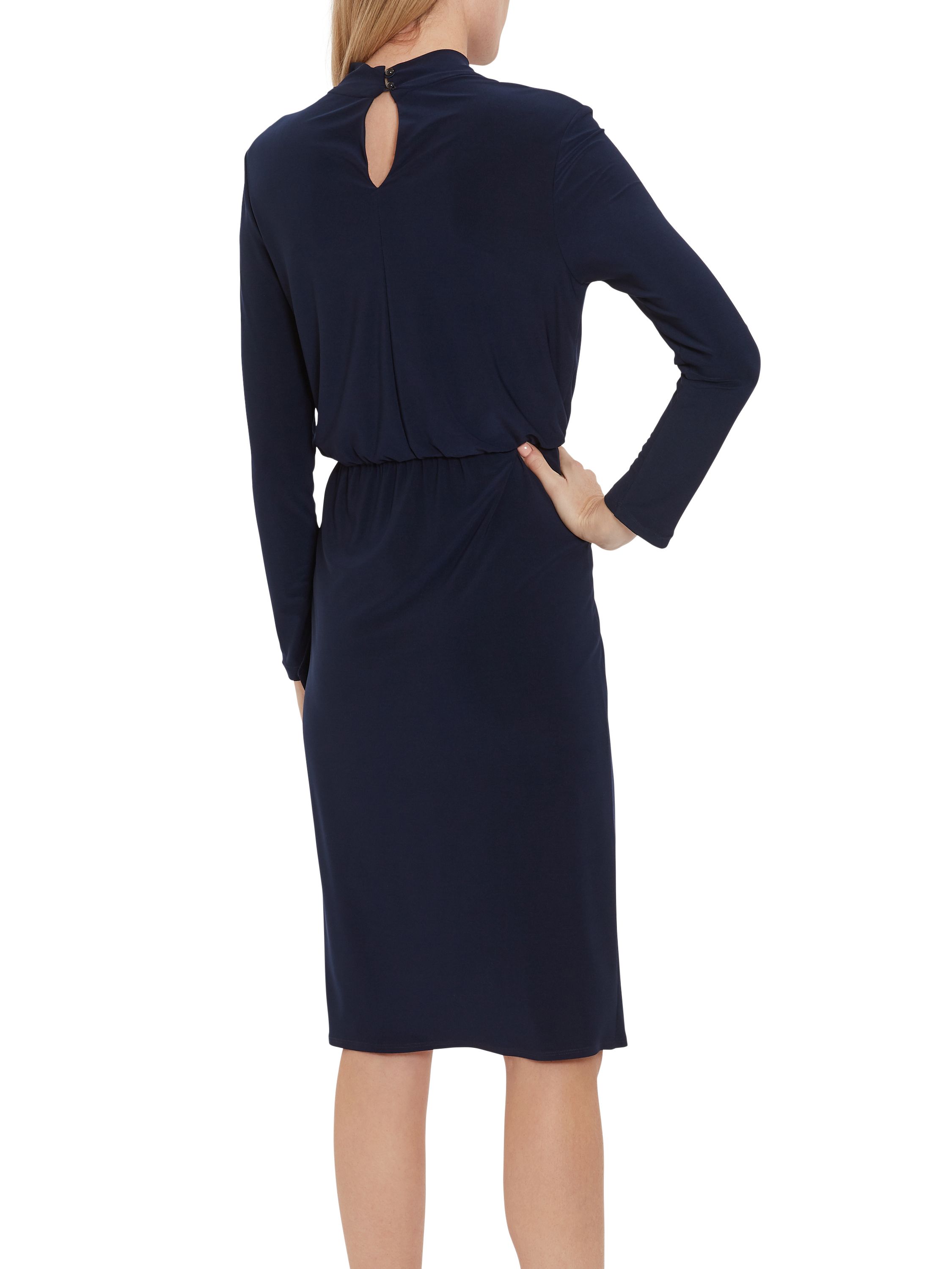 Feel fabulous in this soft stretch jersey dress by Gina Bacconi. It has long sleeves and keyhole neck detailing, with delicate ruching at the waistline and a wrap over style finish. Perfect for day to evening wear. The dress is fully lined.