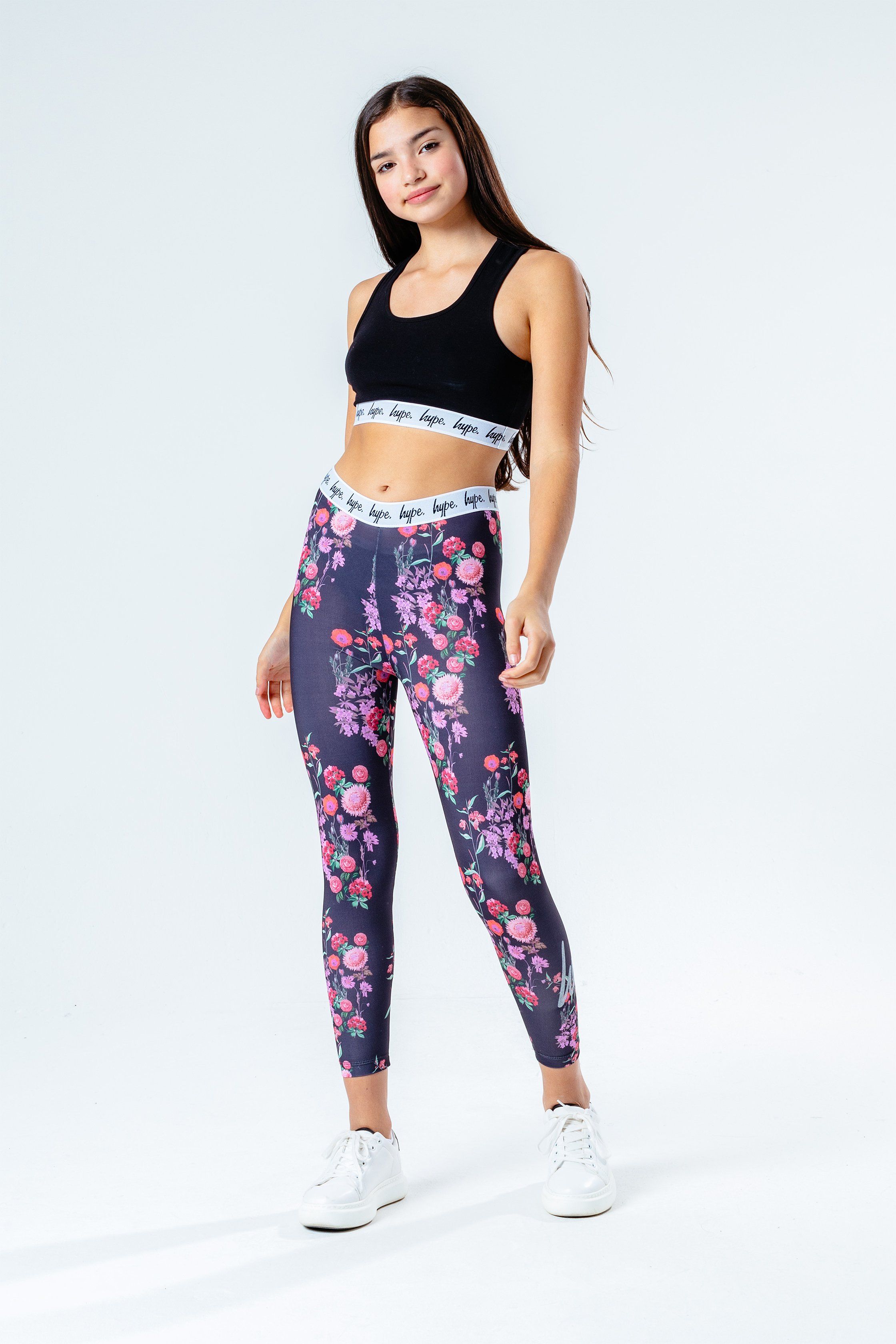 The HYPE. Ditsy Floral Kids Leggings are perfect to add to your everyday rotation. In a pink, peach, green and black colour palette in our standard kids legging shape. With an embossed monochrome elasticated waistband in a micro poly fabric for the ultimate comfort. Boasting an all-over floral print. Finished with the iconic HYPE. script logo in a  glitter transfer. Wear the matching kids crop tee to complete the look. Machine wash at 30 degrees.