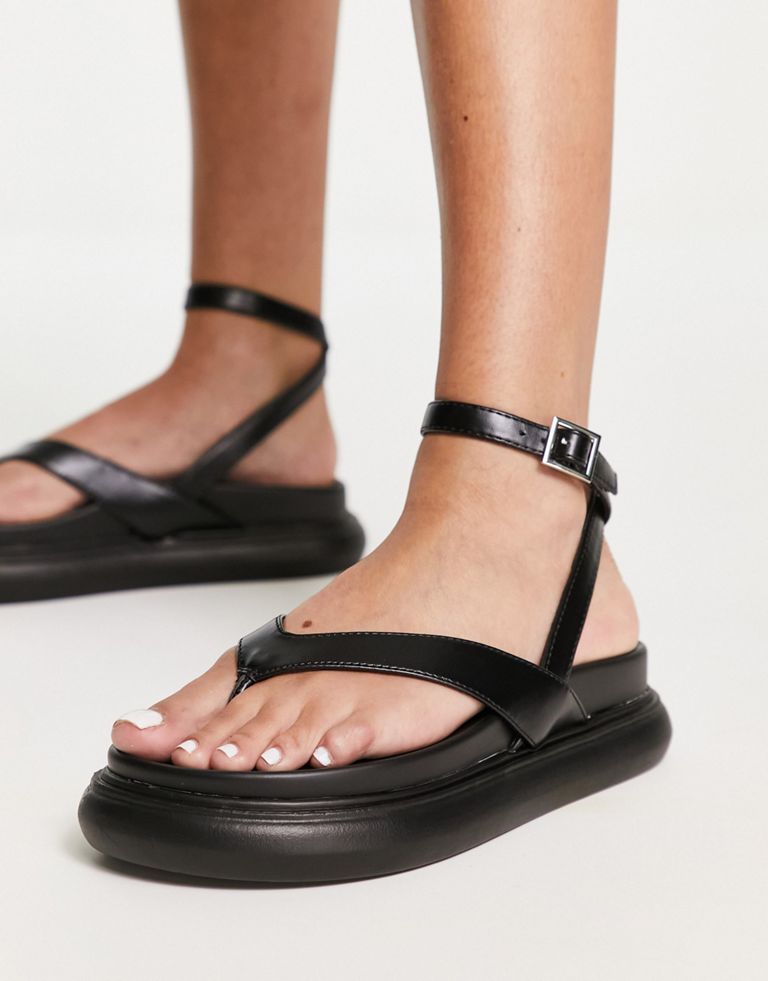 Sandals by ASOS DESIGN It's open-toe season Adjustable ankle strap Pin-buckle fastening V-shaped straps Toe post Chunky sole Sold by Asos