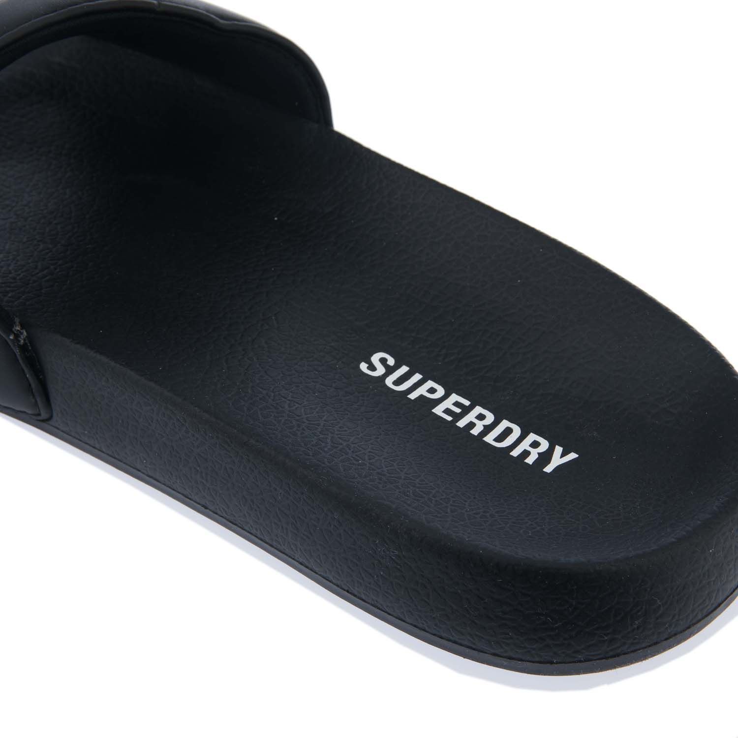 Mens Superdry Code Core Pool Slides in black.- Synthetic upper.- Slip on fastening.- Embossed Superdry logo on side.- Branded footbed.- Moulded sole with a Superdry logo.- Synthetic upper  Textile and synthetic lining.- Ref: MF310199A33B