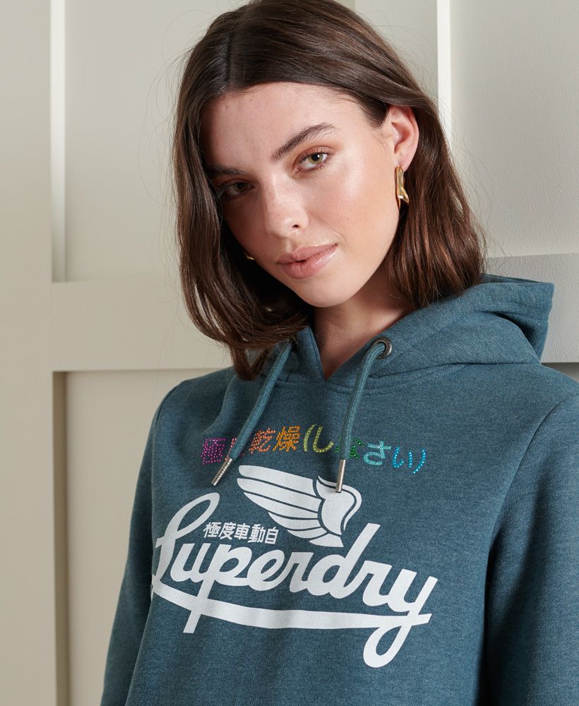 Looking for a relaxed vintage feel? Look no further with Rainbow Pop Classic Hoodie, designed to be a blast from the past.Relaxed fit – the classic Superdry fit. Not too slim, not too loose, just right. Go for your normal sizeDrawstring hoodRibbed cuffs and hemFront pouch pocketSoft brushed liningPrinted graphic with rhinestonesSignature logo tab