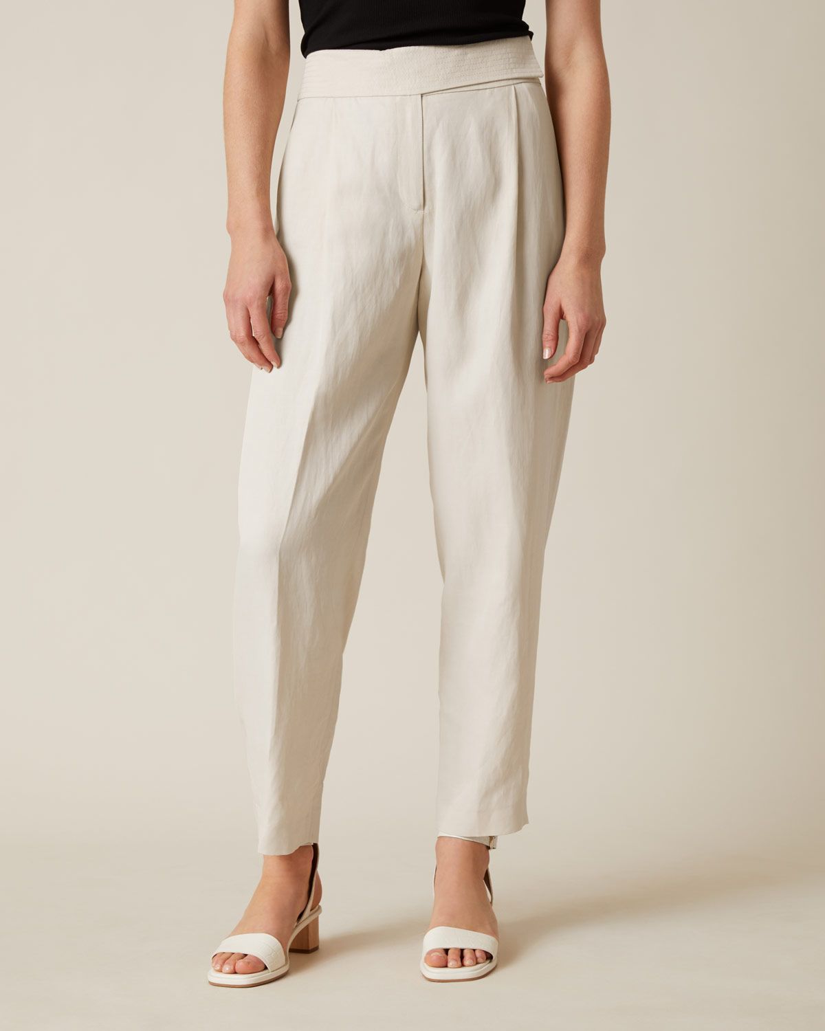 Italian linen trousers. Slightly wider at the thigh. Narrow and multi-stitched hem. Subtle textural twills for fluid effect.