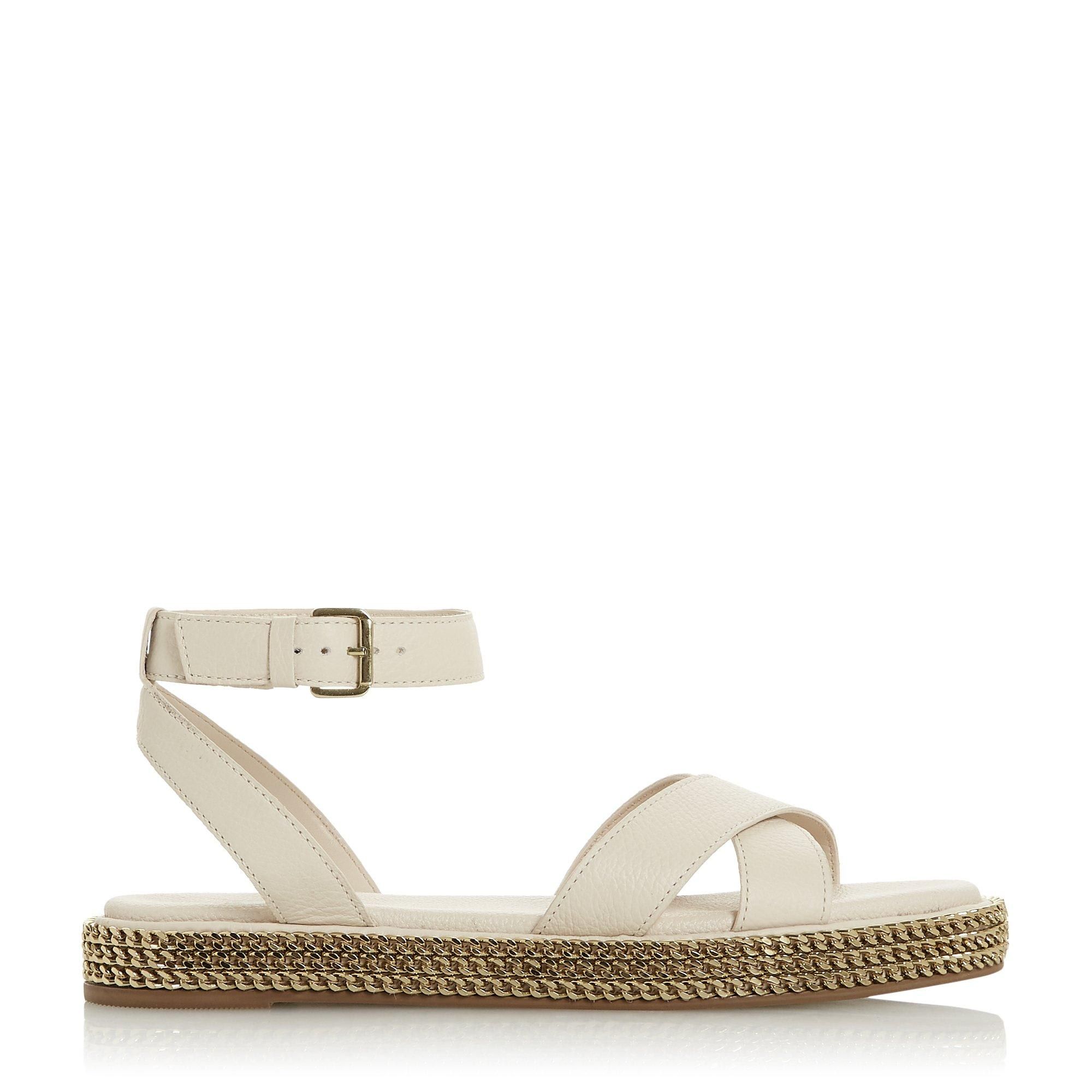 Toughen up summer and holiday edits with this sandal. Fitted with a buckled ankle strap and crossed bands at the upper. Its comfortable chunky sole is embellished with striking chains.