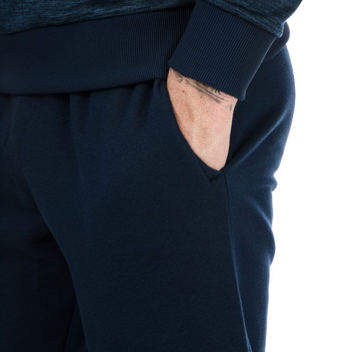 Mens Under Armour Rival Fleece Jog Pants in navy.<BR><BR>-  Inner drawcord to the waistband.<BR>- Ribbed cuffs and waistband.<BR>- Two side pockets.<BR>- Iconic branding to the right leg.<BR>- Ultra-soft  mid-weight cotton-blend fleece with brushed interior for extra warmth.<BR>- 80% Cotton  20% Polyester.  Machine washable. <BR>- Ref: 1357128408