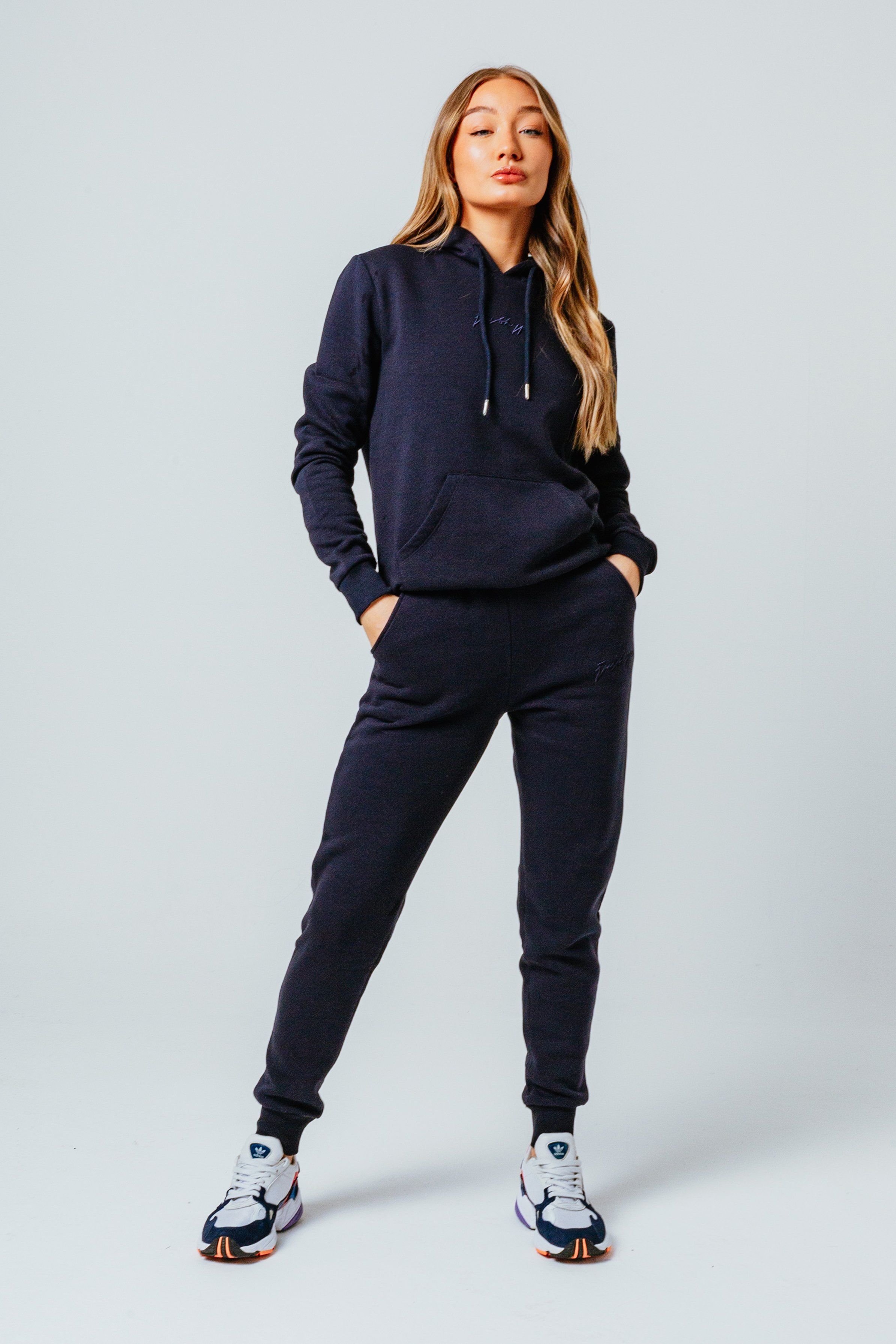 Introducing the freshest loungewear set you've ever seen! The Hype Navy Scribble Women's Tracksuit Set is your new go-to loungewear set when you need that extra comfort boost. Designed in 80% Cotton 20% Polyester for the ultimate soft touch feeling! The Hoodie features a fixed hood, kangaroo pocket, fitted hem and cuffs, finished with drawstring pullers and embossed justhype embroidery across the front in the same colour. The Joggers highlight an elasticated waistband, fitted cuffs and double pockets with tonal drawstring pullers and embossed justhype embroidery on the side of the leg. Wear together or stand alone with a pair of box fresh kicks. Machine washable. 
