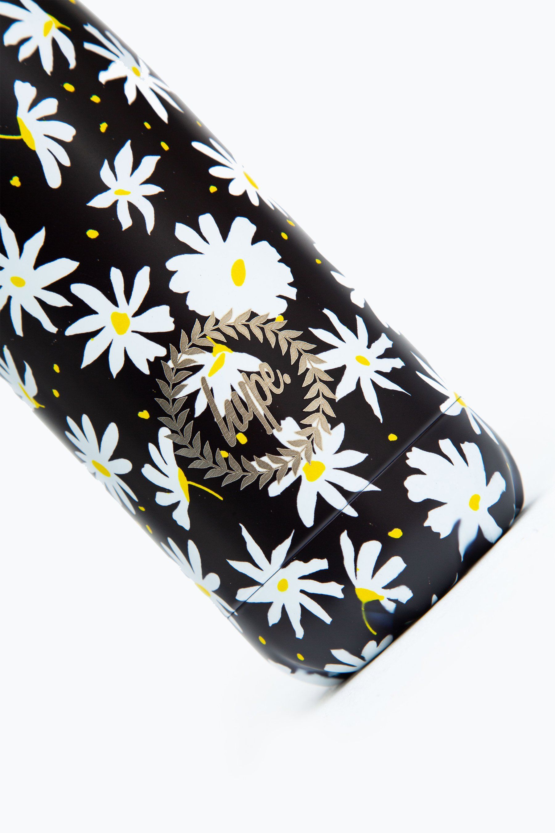 Meet the HYPE. Black Daisies Metal Reusable Bottle, perfect for when you're on the go. Designed in Aluminium to ensure your water stays ice-cold and for chillier days, keeping your oat milk latte warm for longer. The design features a monochrome colour palette with a yellow injection, boasting an all-over daisy repeat print. Finished with the iconic HYPE. crest logo in white on the front. Why not grab one of our lunch bags or backpacks with a bottle holder to complete the look, we suggest grabbing the matching set.