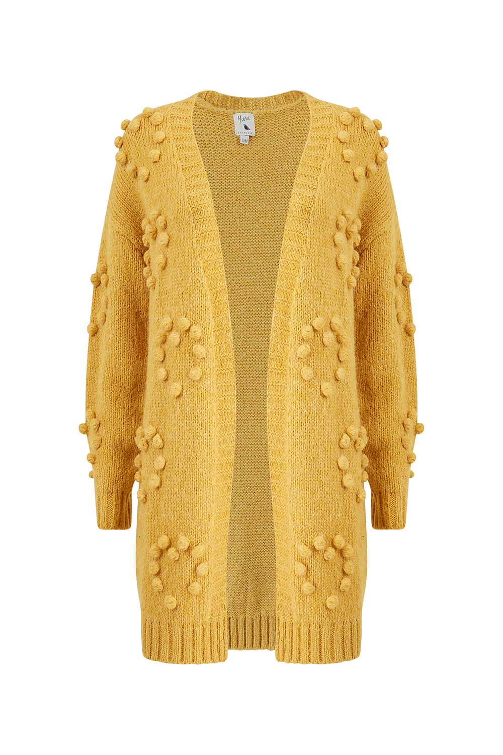 Super soft and in a stunning mustard, this Yumi Mustard Knitted Pom-Pom Heart Long Cardi features statement hand knitted pom poms crafted in heart shaped patterns. A gorgeous, relaxed long cardigan perfect for layering and causal yet cosy weekend wear.