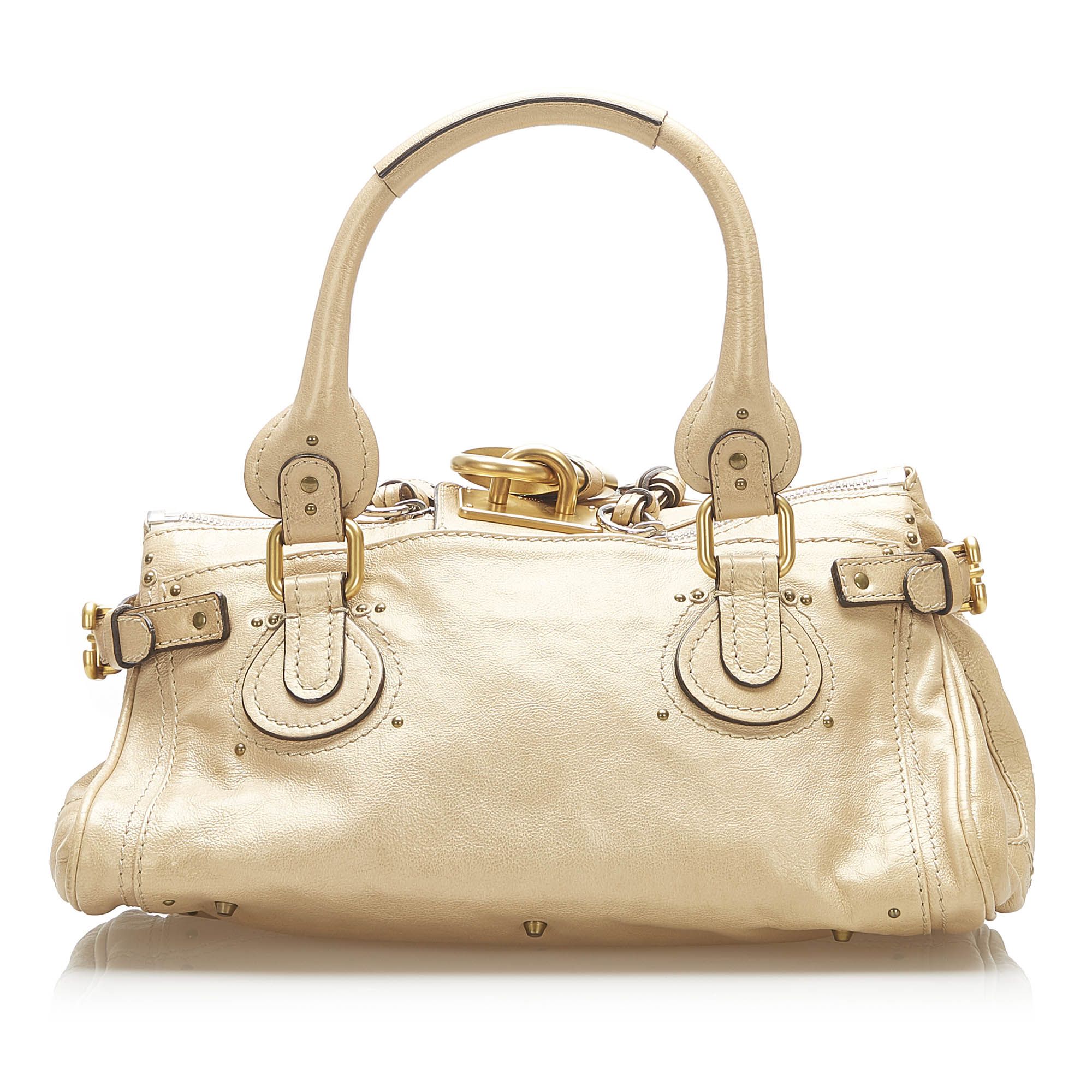 VINTAGE. RRP AS NEW. The Paddington handbag features a leather body, a rolled leather handles, a gold-tone padlock detail, a top zip closure, and an interior zip pocket.Exterior back is discolored. Exterior bottom is discolored. Exterior corners is discolored. Exterior front is discolored. Exterior handle is discolored. Exterior side is discolored. Studs is tarnished. Zipper is tarnished.

Dimensions:
Length 19cm
Width 35.5cm
Depth 16cm
Hand Drop 18cm
Shoulder Drop 17cm

Original Accessories: Dust Bag, Authenticity Card

Color: Brown x Beige
Material: Leather x Calf
Country of Origin: France
Boutique Reference: SSU94359K1342


Product Rating: GoodCondition