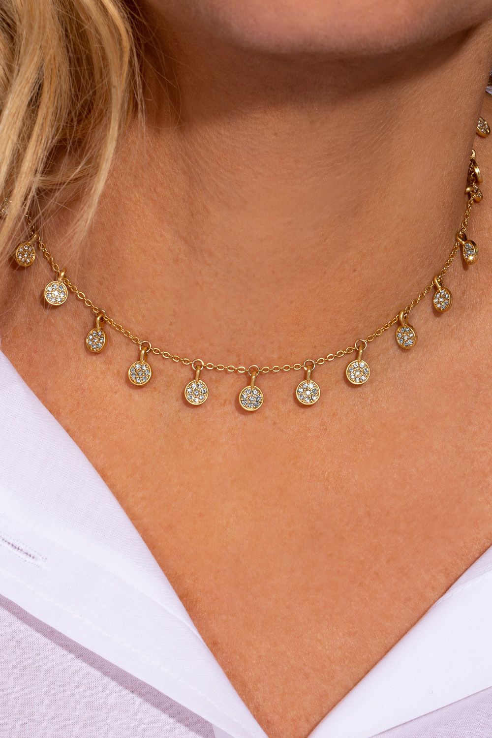 If you love your boho jewellery with a sparkly twist, this choker necklace has your name all over it! It features a dainty gold choker with miniature coins that dance across your neck. The gold plated necklace features pavé detailing with sparkling clear stones and it's perfect for layering with another longer necklace with a low neckline outfit, or over the top of a jumper during the day! It measures 15 inches and comes with a 3 inch extender. The Boho pave choker necklace is designed as a laid back piece with a glamorous twist that you can wear with so many looks!