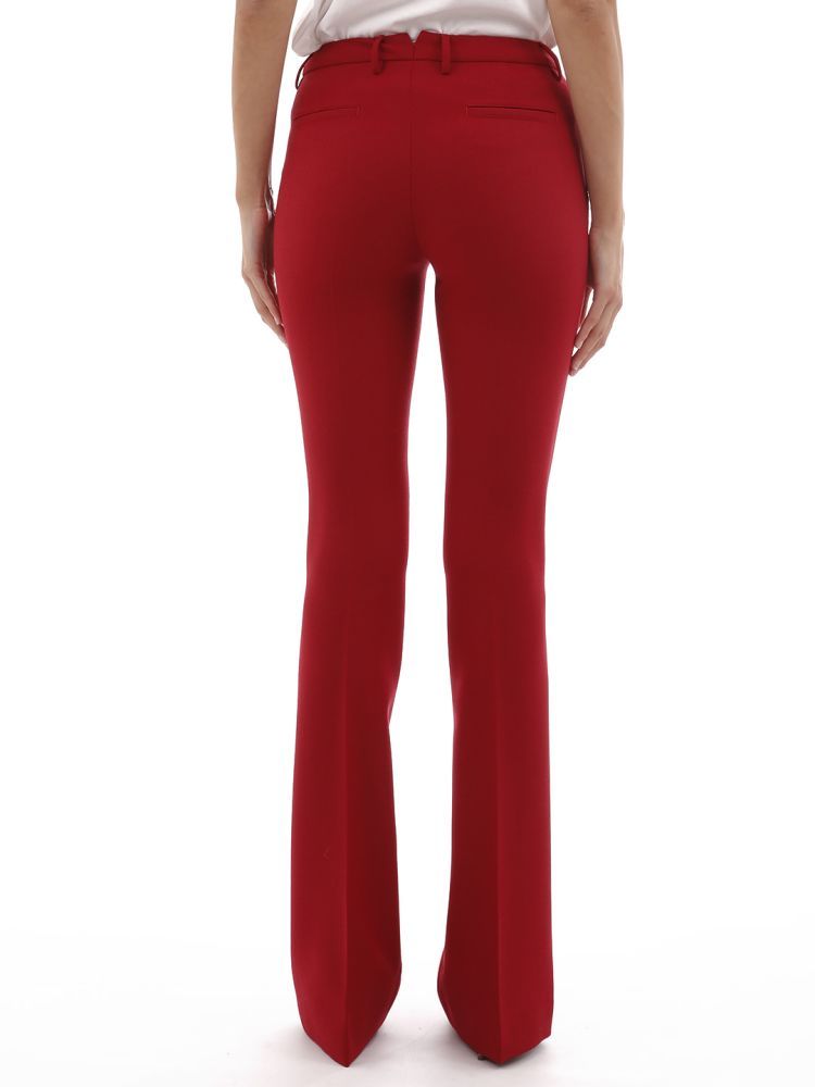 Red trousers made of stretch wool. With a flared design with a central line, it has two side pockets and two back pockets. Zipper and button closure and belt loops at waist.The model is 1,77 tall and wears size S / 40IT / 26US / 36FR / 8UK