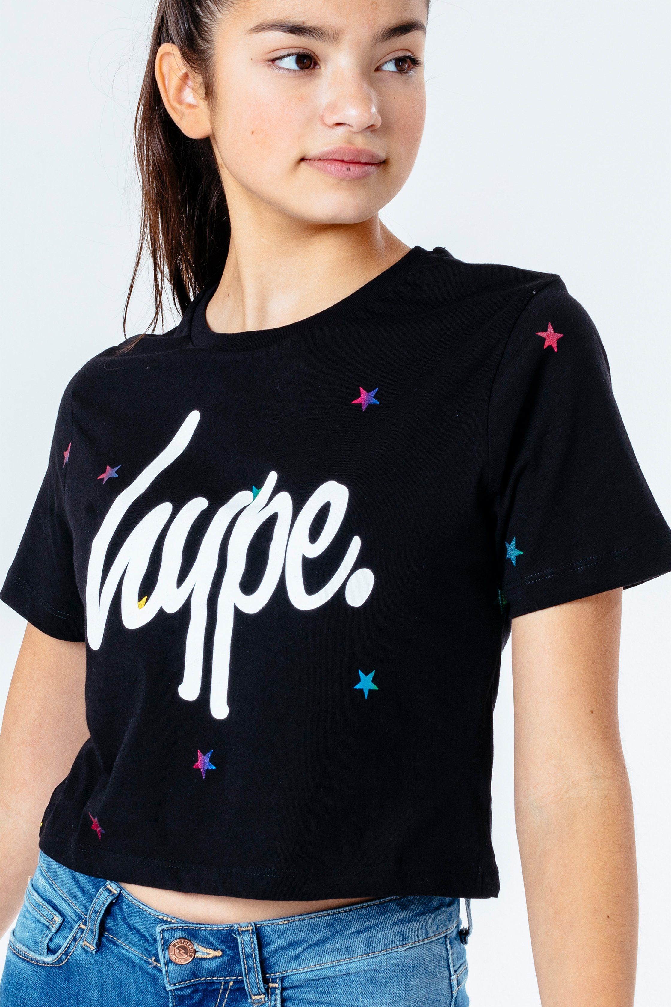 The HYPE. Magic Star Kids Crop T-Shirt is your new go-to tee. Designed in a black 100% cotton fabric base for supreme comfort in our standard crop t-shirt shape, highlighting a crew neck line and short sleeves. With an all-over star print in a rainbow transfer. Finished with the iconic HYPE. script logo in a contrasting white. Wear with the matching runner shorts to complete the look. Machine wash at 30 degrees.