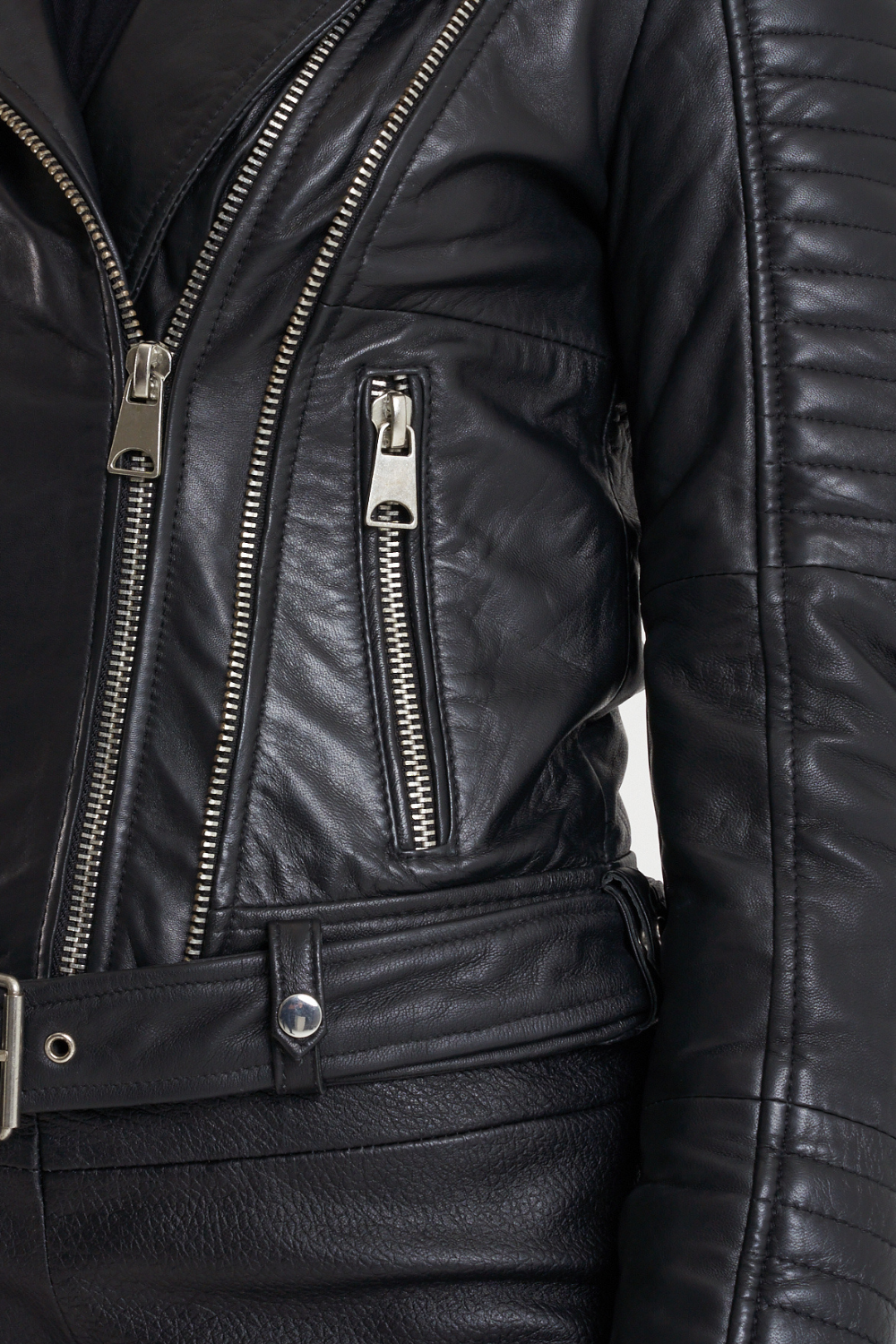 This leather jacket features all the hallmarks of an iconic racer jacket; tab neck collar, adjustable waistbelt and asymmetric zipline. This gorgeous piece also features unique ribbed shoulder detailing that is wadded for extra dimension.
