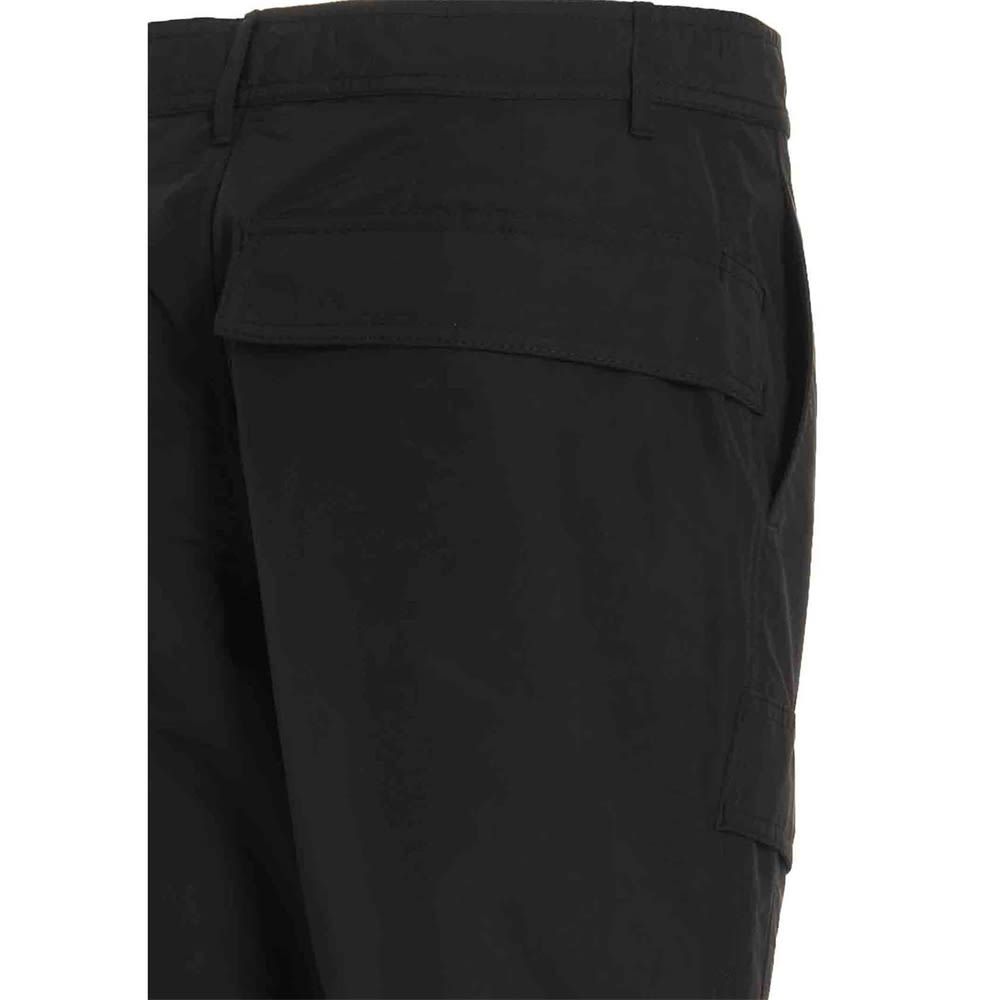 Cargo pants in tech fabric, featuring a zip and button closure and pockets.