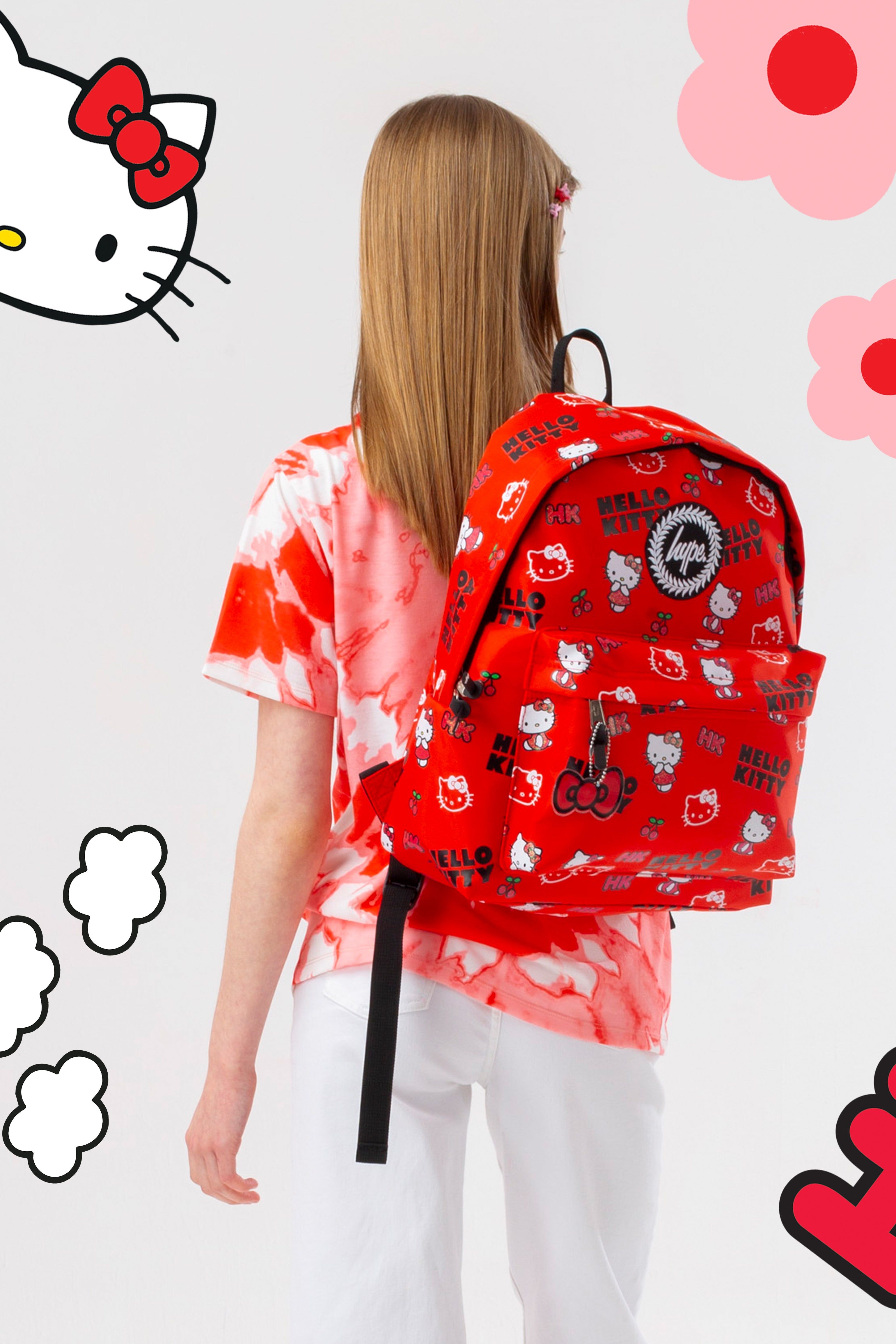 You can never have too many backpacks! Meet the HYPE. X Hello Kitty Mini Print Backpack, part of our brand new collaboration collection and your new go-to accessory. Designed in our standard backpack shape in a red nylon fabric, boasting screen print detail, navy glitter, bow charm detail, and the iconic HYPE. crest logo. 