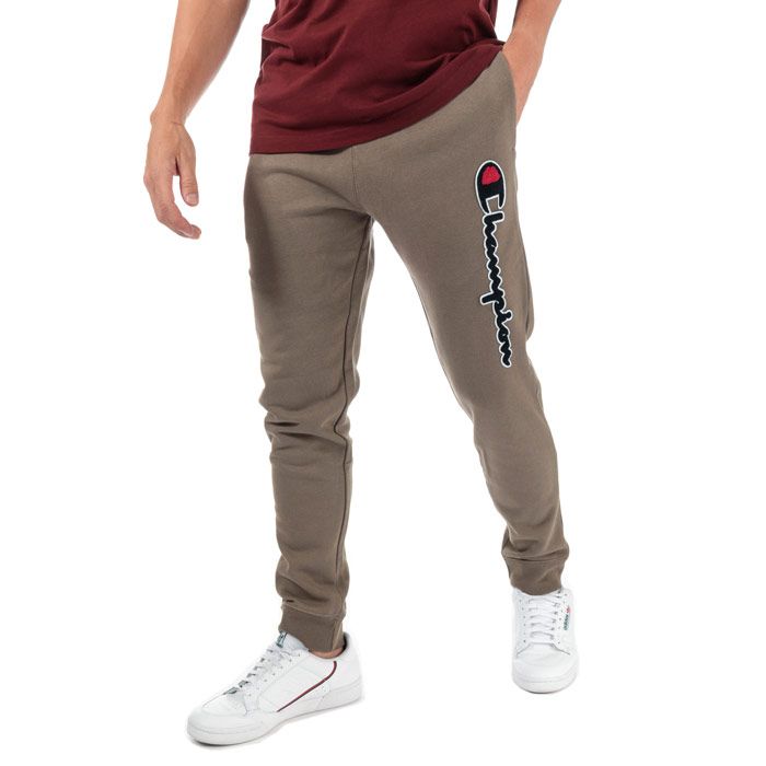 Mens Champion Large Logo Jog Pants in brown.<BR><BR>- Ribbed elasticated waist with drawcord.<BR>- Side seam pockets.<BR>- Cotton terry script logo at left leg.<BR>- Signature C logo embroidered at left hip.<BR>- Ribbed cuffs.<BR>- Regular fit.<BR>- 100% Cotton.  Machine washable.<BR>- Ref: 213515 MS051