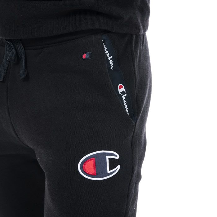 Mens Champion Suede C Logo Jog Pants in black.<BR><BR>- Elasticated waist with drawcord.<BR>- Front slant pockets with branded tape trim.<BR>- Suede-textured C logo embroidered at left hip.<BR>- Ribbed cuffs.<BR>- Custom fit.<BR>- 100% Cotton.  Machine washable.<BR>- Ref: 213529 KK001
