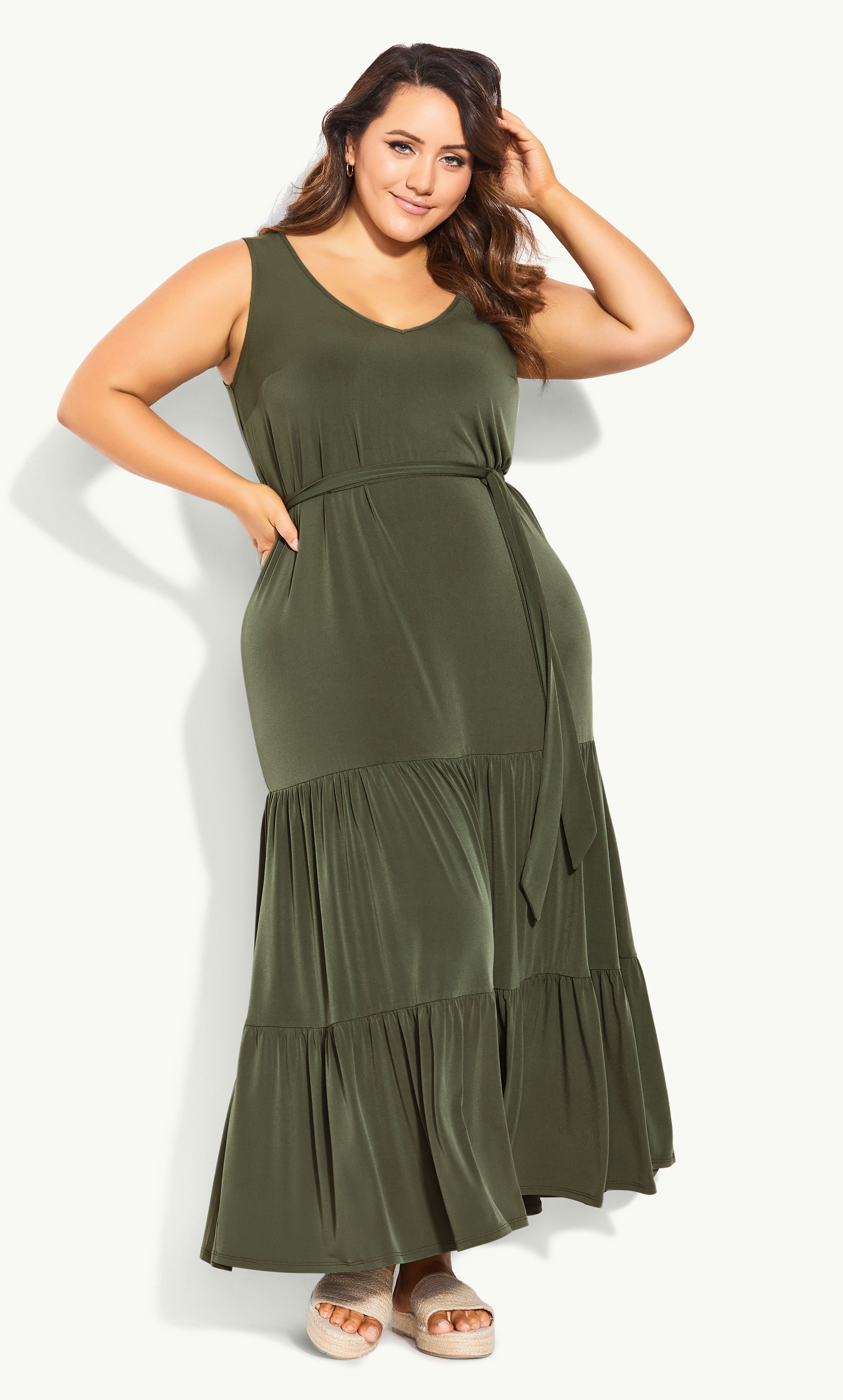 Boasting a trending khaki hue, the Tiered Sleeveless Maxi Dress is bound to become your summer go-to. It features a classic V-neckline and sleeveless cut, with a draping tiered hemline that floats ever so elegantly in motion. Key Features Include: - V-neckline - Sleeveless - Self-tie fabric waist belt - Pull over style - Relaxed fit - Unlined - Maxi length - Ruffle tiered hemline Tie up your look with tan-hued sandals, a pair of cat-eye sunglasses and a chic rattan bag. Summery perfection!