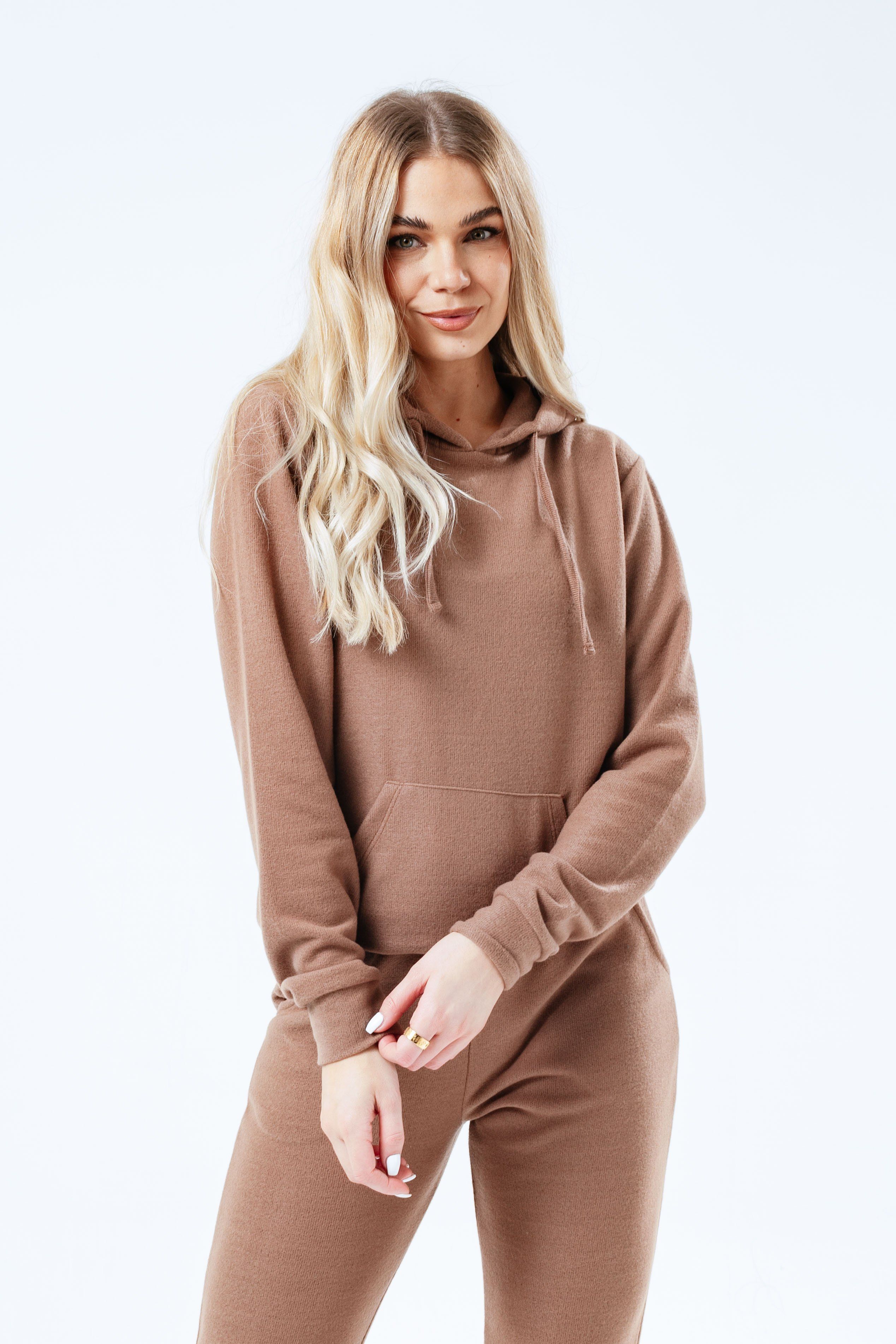Loungewear is still in! Put comfort first in the HYPE. Brown Faux Knit Womens Tracksuit Set. Designed in a brown colour palette in a 100% polyester fabric base for the ultimate soft-touch and breathable space. The womens hoodie feature a fixed hood, kangaroo pocket, drawstring pullers and fitted cuffs and hem. The joggers boast an elasticated waistband, with fitted cuffs and drawstring pullers. Wear together or as stand alone pieces. Machine Washable.