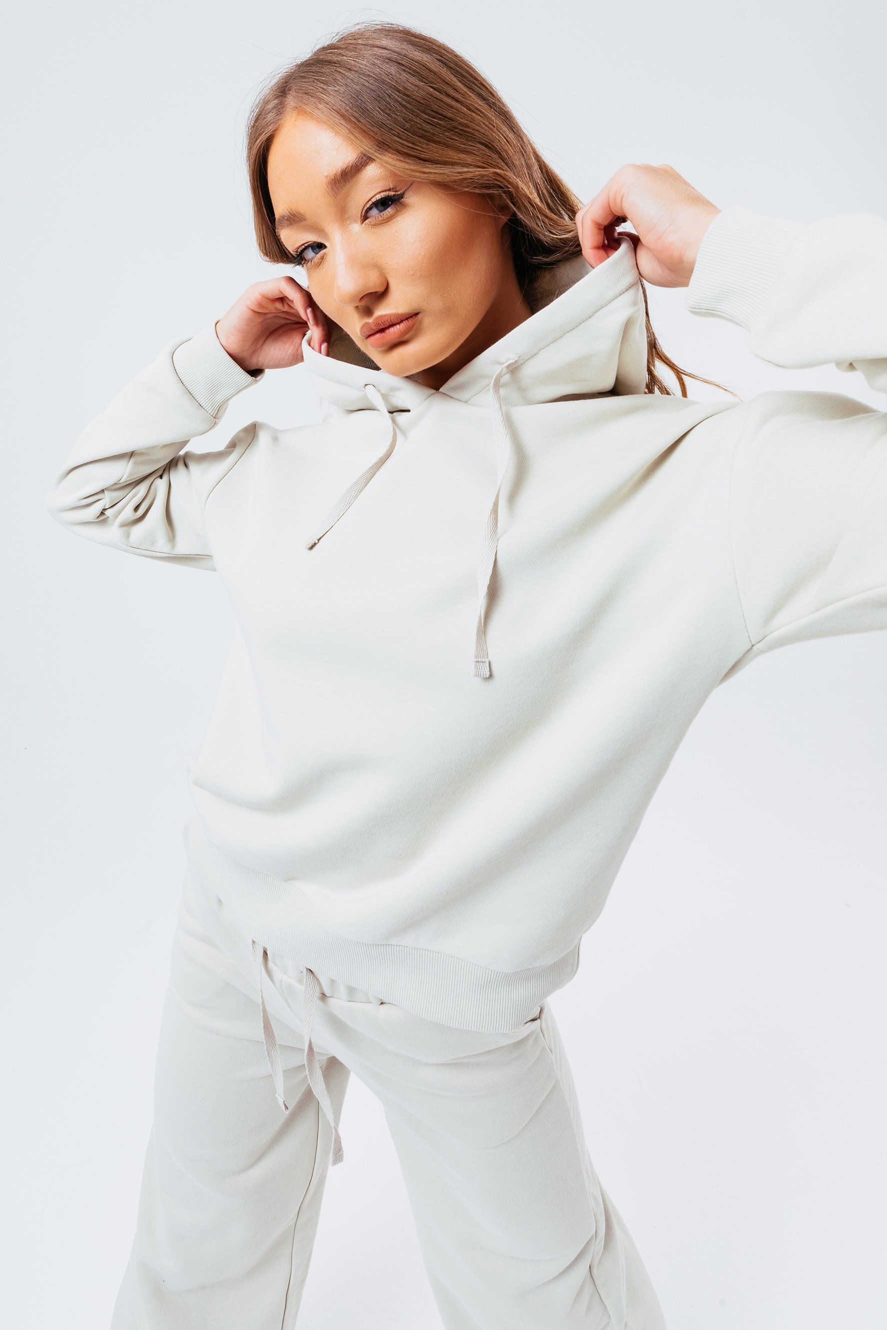 The HYPE. Nude Sweat L/S T-Shirt and Flared Joggers Women's Loungewear Set if your new go-to everyday essential. Both garments boast a 80% Cotton and 20% Polyester fabric base for the ultimate comfort and breathable room. The top boasts our standard Women's long-sleeved tee with drawstring pullers, fixed hood and fitted cuffs. The flared trousers highlight an elasticated waistband, drawstring pullers with a flared long leg. Wear together to complete the set or stand alone paired with seasonal favourites. Machine washable.