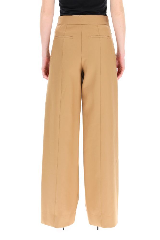 BURBERRY high-waisted trousers in cotton twill with a wide-leg cut, featuring a front flap with buttons inspired to sailor's uniforms. Concealed zip closure. Side slip pockets, rear welt pockets with buttons. The model is 177 cm tall and wears a size UK 6.