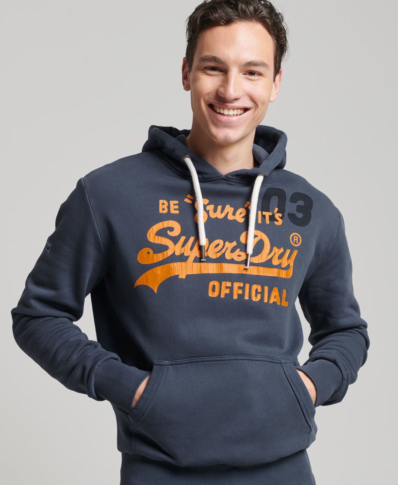Your classic hoodie sorted. The Vintage Logo American Classics Hoodie is that staple everyone needs in their wardrobe. This hoodie features a drawstring fastened hood, front pocket and long sleeves with a stitched badge. Finished off with Superdry's printed original logo. Pair with joggers for that comfy stay at home vibe.Slim fit – designed to fit closer to the body for a more tailored lookFront pocketDrawstring fasteningStitched badge