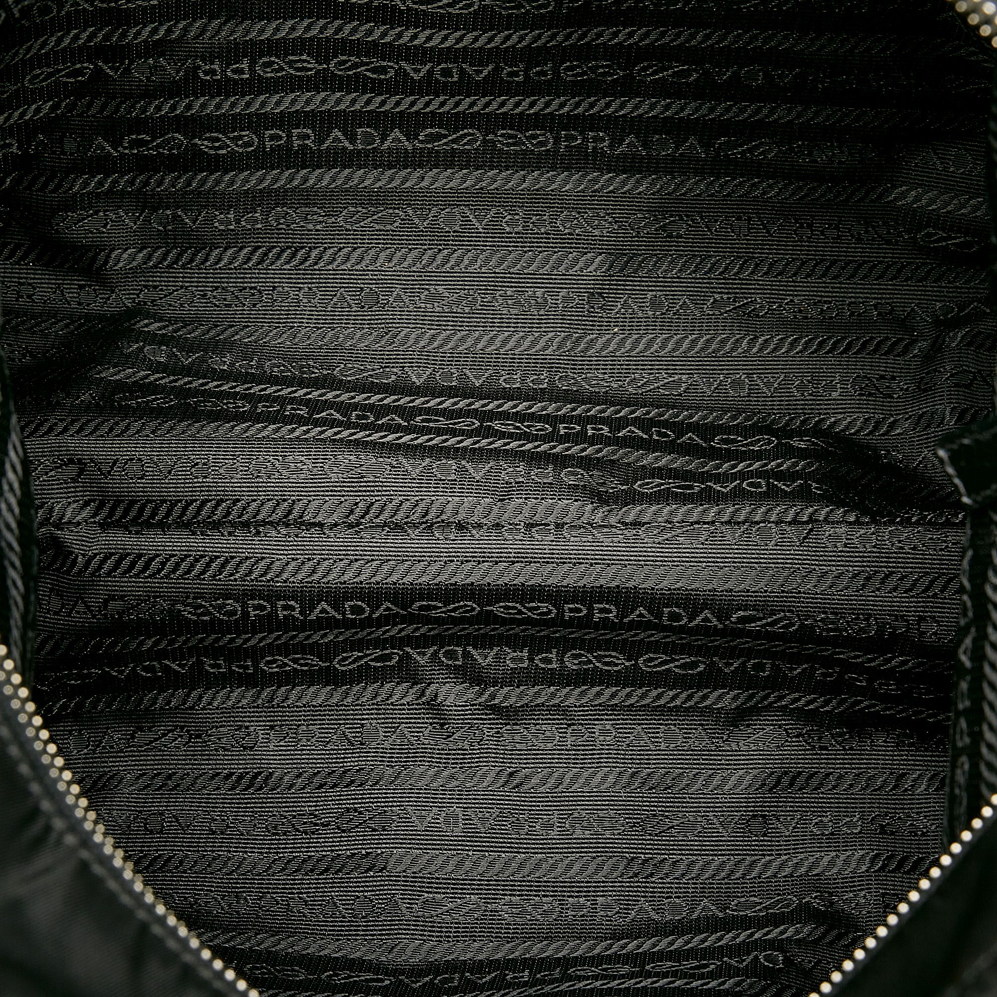 VINTAGE. RRP AS NEW. This shoulder bag features a nylon body with leather trim, an exterior front slip pocket, flat leather handles, a top zip closure, and an interior zip pocket.Exterior back is discolored, out of shape and scratched. Exterior bottom is discolored, out of shape and scratched. Exterior front is discolored, out of shape and scratched. Exterior handle is cracked, discolored, out of shape and scratched. Exterior side is discolored, out of shape and stained with others. Buckle is scratched. Zipper is scratched.

Dimensions:
Length 24cm
Width 35cm
Depth 10cm
Shoulder Drop 20cm

Original Accessories: This item has no other original accessories.

Color: Black
Material: Fabric x Nylon x Leather x Calf
Country of Origin: Italy
Boutique Reference: SSU163652K1342


Product Rating: GoodCondition

Certificate of Authenticity is available upon request with no extra fee required. Please contact our customer service team.