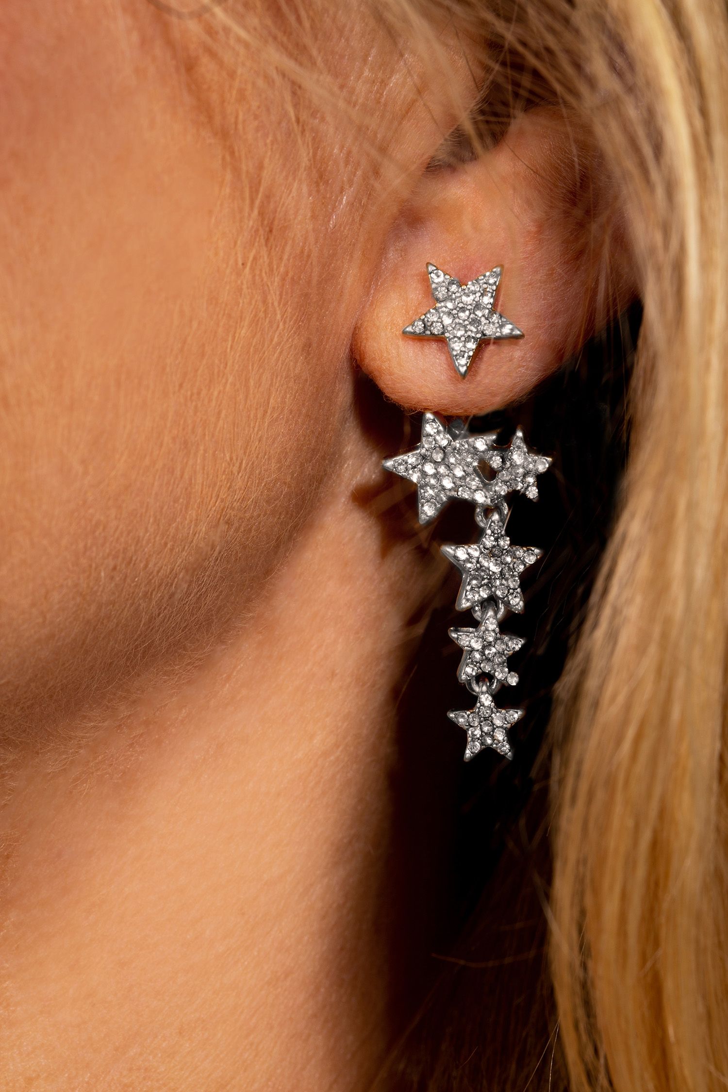 This might be the cleverest earring design you ever did see! One earring, three ways to work it! First as a simple sparkling star stud, then simply attach the gorgeous cascading stars one of two ways, either behind or in front of the ear for two glammed up looks that are bang on trend this season. These silver plated star earrings star move delicately and shimmer in the light, and can be teamed as a set with the matching Sparkling Stars silver necklace and bracelet.
