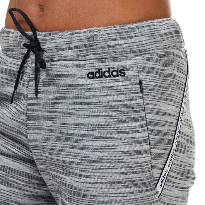 Womens adidas Xpressive 7-8 Joggers in grey black.- Elasticated waistband with drawstring fastening.- Seven-eighth length.- Side zip pockets.- Lightweight.- Cropped construction.- Signature logo and are complete with adidas branding.- Breathable.- Open hems.- Regular fit.- 52% Cotton  48% Polyester (Recycled) . Machine washable. - Ref: EI5508