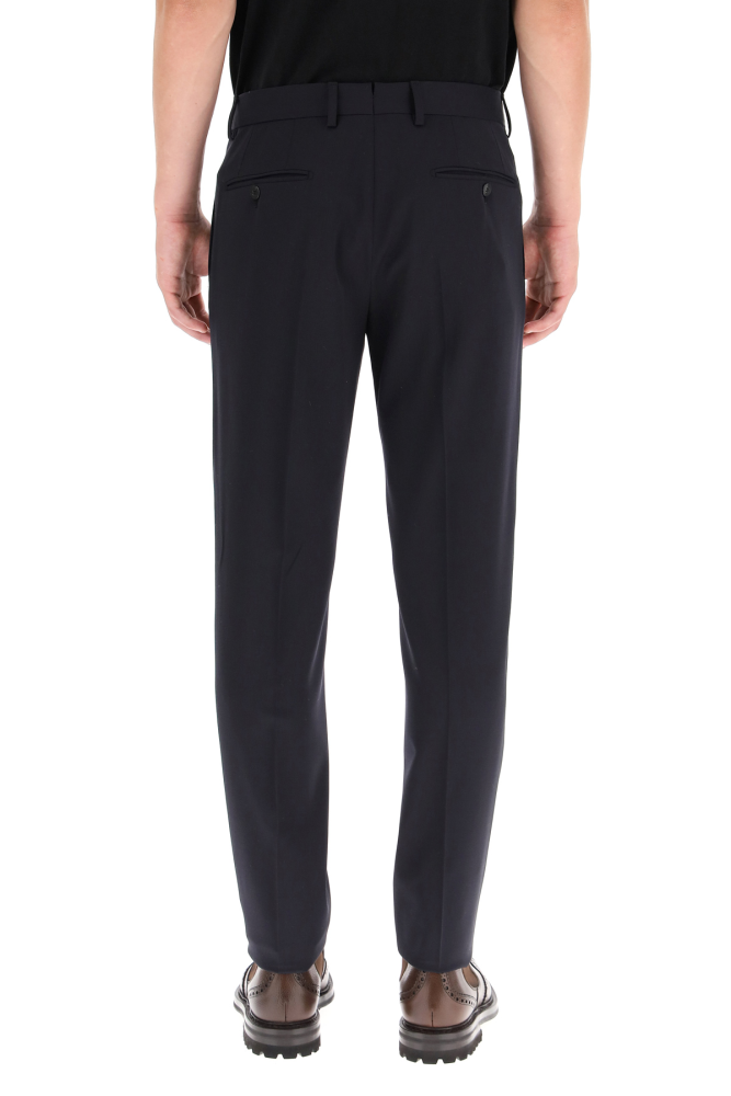 Caruso tailored trousers crafted in the iconic Houdini stretch wool fabric. Straight leg cut with ironed crease, concealed zip and button closure, side slanted pockets, rear jetted pockets with button, invisible fifth pocket. The model is 185 cm tall and wears a size IT 46.