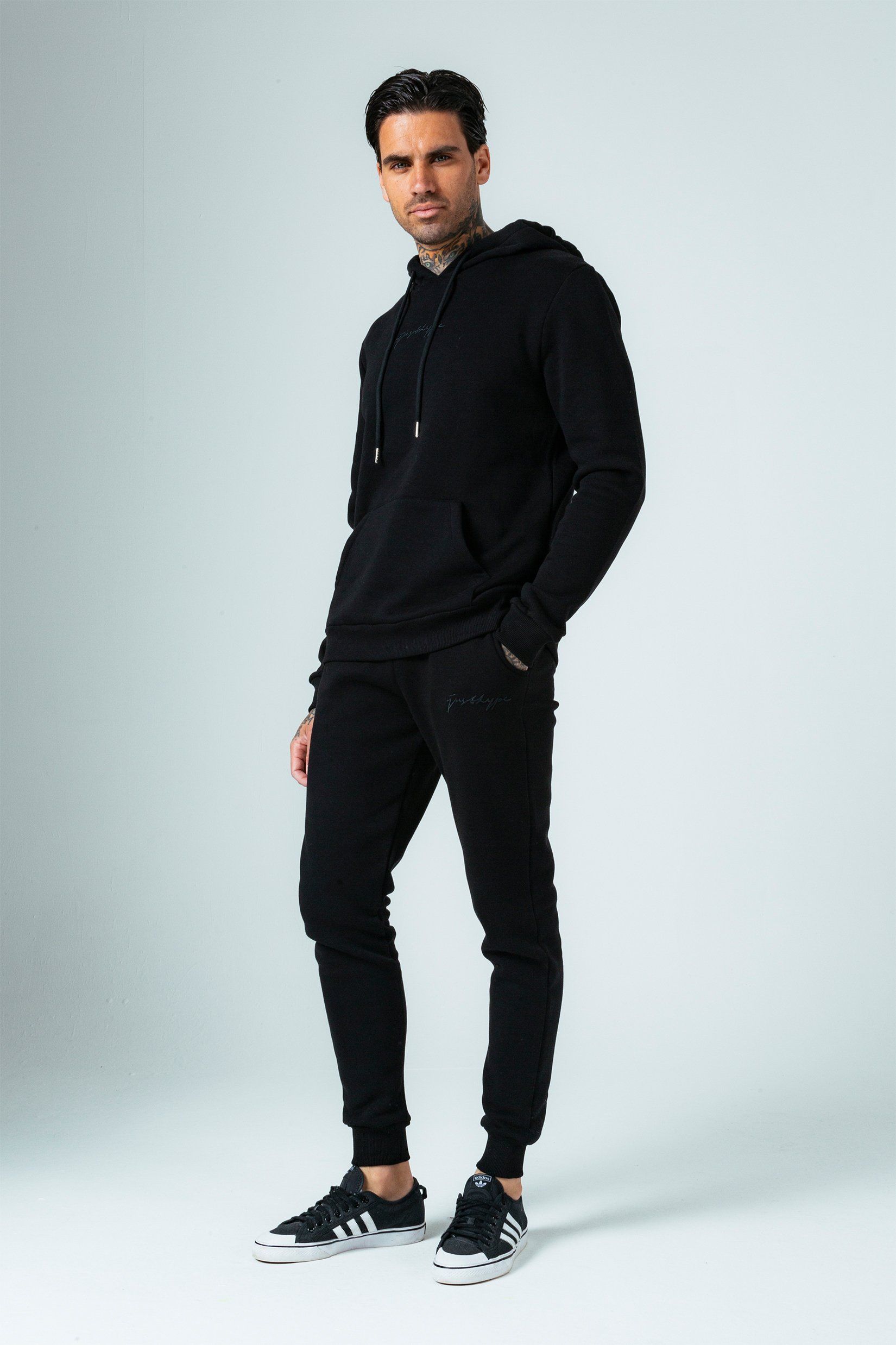 Introducing the freshest loungewear set you've ever seen! The Hype Black With Black Signature Script Men'S Hoodie & Jogger Set is your new go-to loungewear set when you need that extra comfort boost. Designed in 80% Cotton 20% Polyester for the ultimate soft touch feeling! The Hoodie features a fixed hood, kangaroo pocket, fitted hem and cuffs, finished with drawstring pullers and embossed justhype embroidery across the front in the same colour. The Joggers highlight an elasticated waistband, fitted cuffs and double pockets with tonal drawstring pullers and embossed justhype embroidery on the side of the leg. Wear together or stand alone with a pair of box fresh kicks. Machine washable. 