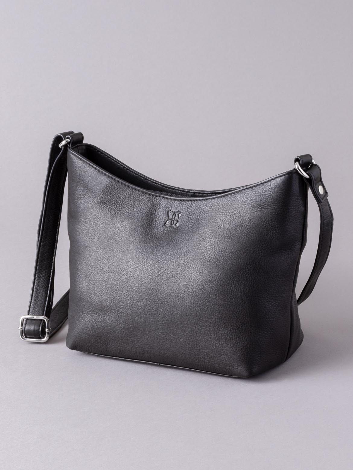 The Fornside is the perfect black cross body bag, crafted from luxuriously soft leather, its minimalist design makes it easy to coordinate with any outfit. A small handbag, it works as a traditional cross body bag, yet the adjustable strap allows it to be carried as a compact shoulder bag, when the occasion requires. Not only does the Fornside handbag look great, it feels fantastic, thanks to our real leather that showcases the natural patina. And practicality is key... we've included a rear zip pocket, and the inside is carefully sectioned, with a zip-top main compartment in the middle, plus two additional sections secured with magnetic studs.