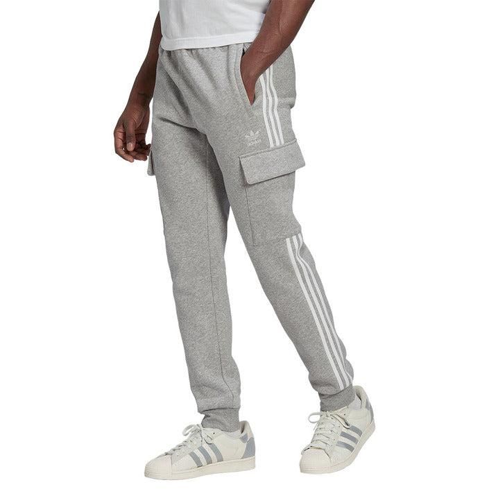 Brand: Adidas
Gender: Men
Type: Trousers
Season: Fall/Winter

PRODUCT DETAIL
• Color: grey
• Pattern: plain
• Pockets: side pockets

COMPOSITION AND MATERIAL
• Composition: -70% cotton -30% polyester 
•  Washing: machine wash at 30°
