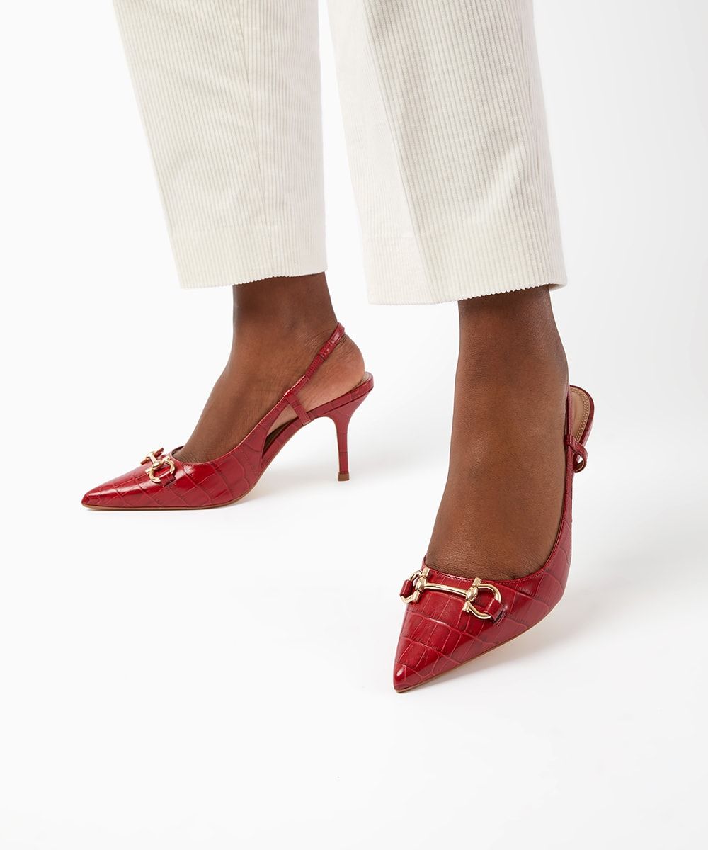 It's the court, but not as you know it. This season, a wardrobe classic is updated thanks to trend-led croc texture and a sleek snaffle trim. The Click slingbacks are further complemented by a comfortable heel, pointed toe and slim straps.