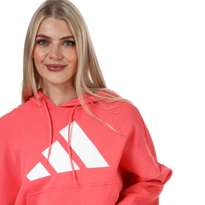 Womens adidas Back Zip Graphic Hoody in coral.- Back zip with hood.- Long sleeves.- Ribbed cuffs and hem.- Doubleknit.- Kangaroo pocket.- Moisture-absorbing AEROREADY.- Loose fit.- Main Material: 67% Cotton  33% Polyester (Recycled).  Machine washable. - Ref: GK2116