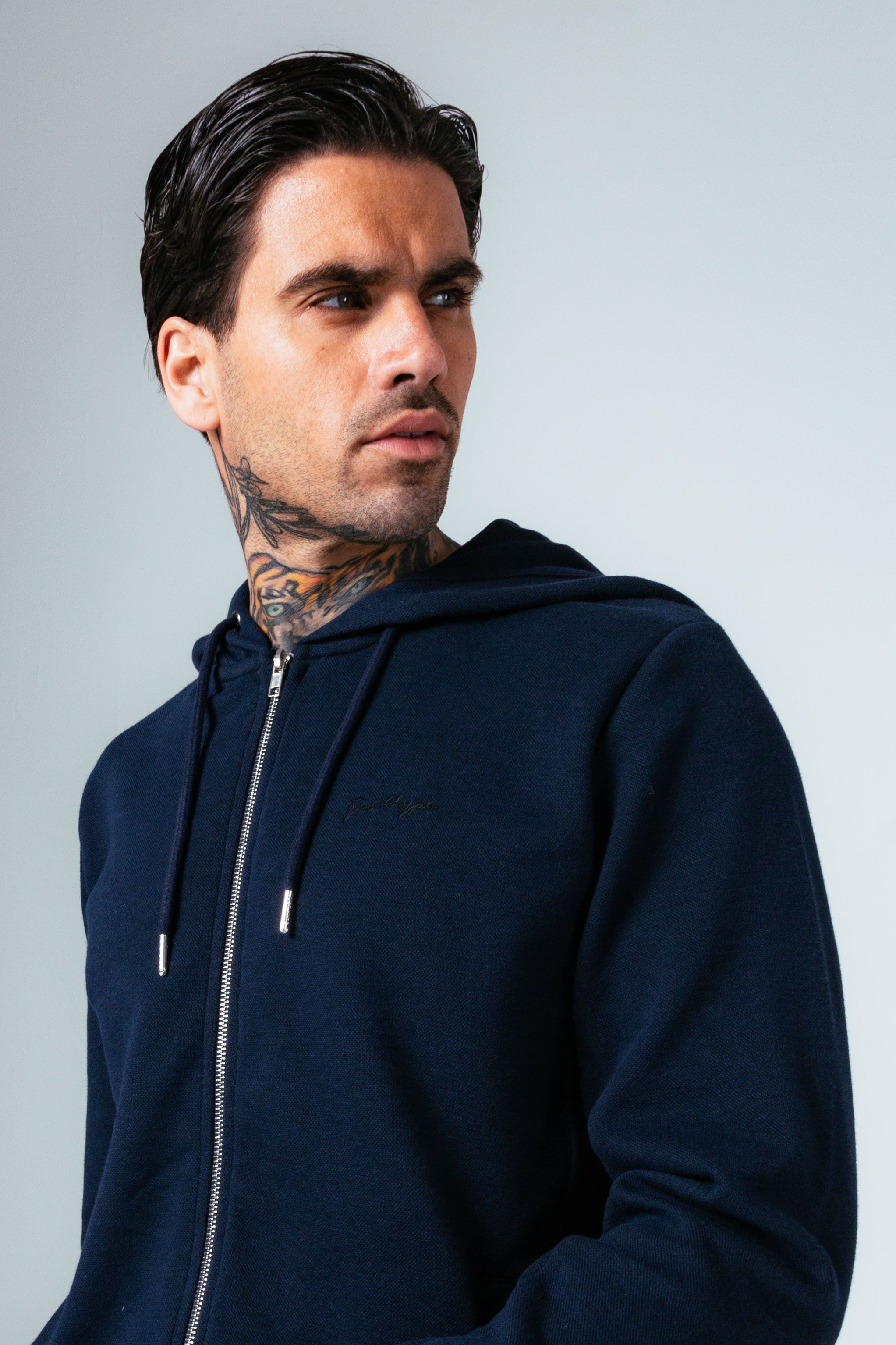 The HYPE. Navy Pique Oversized Men's Pullover Hoodie is your new go-to everyday essential. Designed in our standard men's jacket shape, with a fixed hood, double pocket sand fitted hem and cuffs. With a 50% cotton and 50% polyester fabric base for supreme comfort and breathable space. With a dark navy colour palette, high neck detail and 5 thread cover stitch. Finished with the new! embroidered just hype signature logo embroidered on the front. Wear with the matching joggers for a smart casual look. Machine washable.