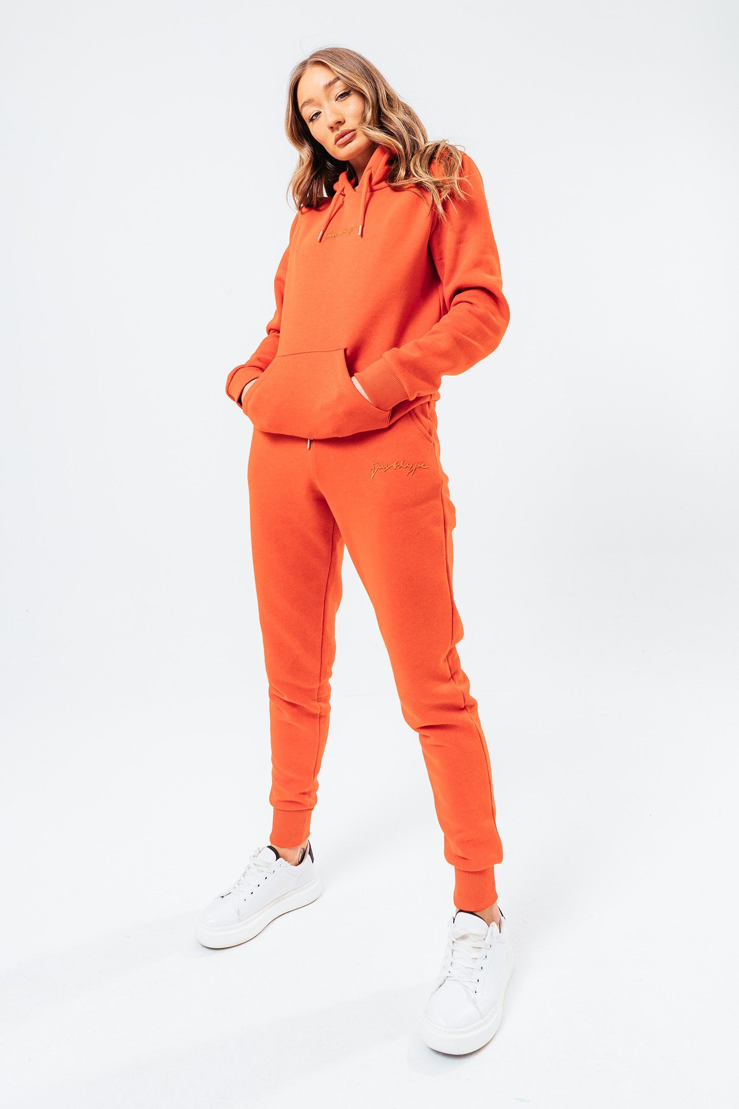 Introducing the freshest loungewear set you've ever seen! The hype dark orange with tonal signature script women's hoodie & jogger set is your new go-to loungewear set when you need that extra comfort boost. Designed in 80% cotton 20% polyester for the ultimate soft touch feeling! The hoodie features a fixed hood, kangaroo pocket, fitted hem and cuffs, finished with drawstring pullers and embossed justhype embroidery across the front in the same colour. The joggers highlight an elasticated waistband, fitted cuffs and double pockets with tonal drawstring pullers and embossed justhype embroidery on the side of the leg. Wear together or stand alone with a pair of box fresh kicks. Machine washable.�