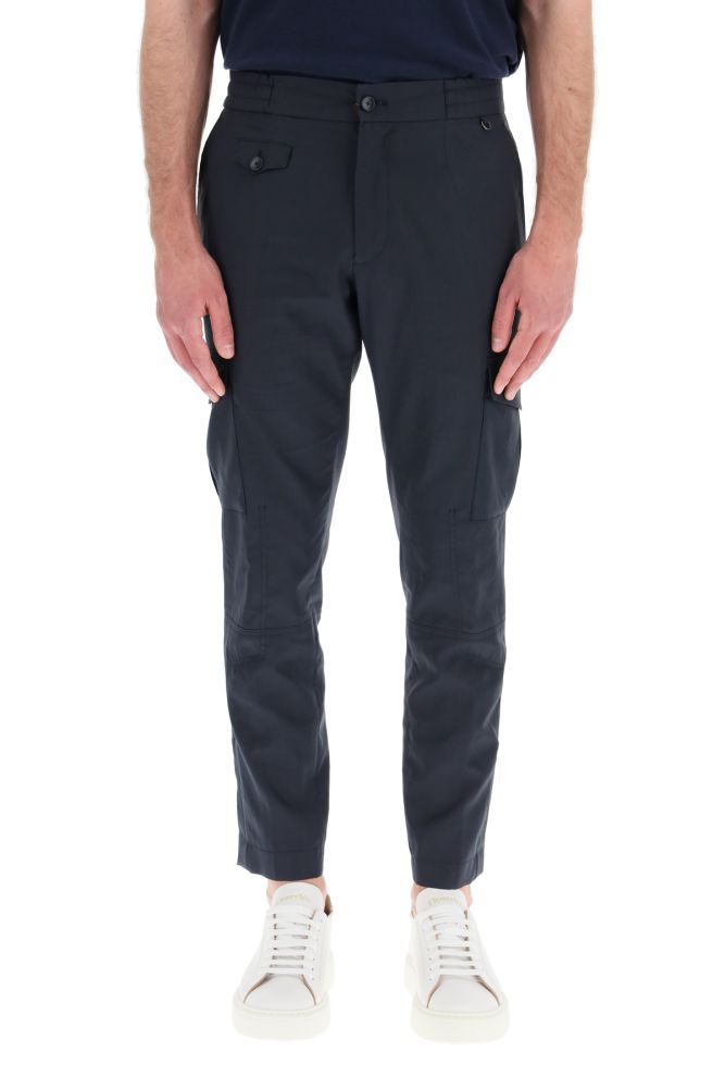 Cargo trousers by ETRO in cotton fabric featuring side pockets with flap, double snap button and central gusset. It features a slightly slim fit with slash pockets, a small front pocket, and back pockets with flap and button. Closure with zip and branded button, elasticated waistband and knotted internal drawstring. The model is 183 cm tall and wears a size IT 46.