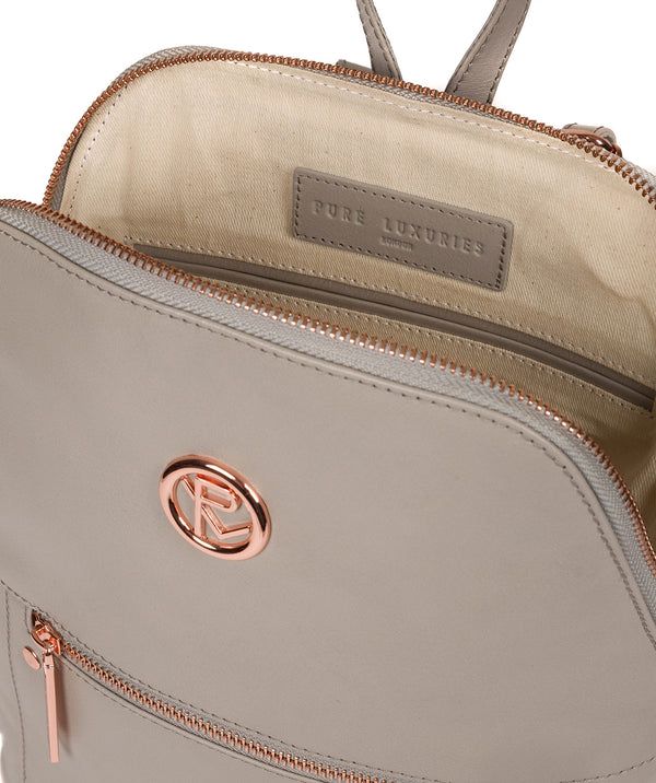 The 'Rubens' backpack from Pure Luxuries London is crafted from beautiful leather that has a luxurious finish. A unique angled zip-round top secures the central compartment, lined with 100% cotton and features two slip pockets. On the front of the bag is a spacious zipped pocket that is ideal for on-the-go storage. Furnished with rose gold-coloured fittings including the Pure Luxuries London logo and embossed charm. Comes with matching, thin leather shoulder straps which are easily adjusted.