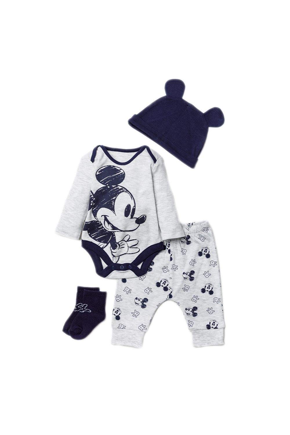 This adorable Disney Baby four-piece set features a classic sketched Mickey Mouse print. The set includes a long sleeved bodysuit, a pair of matching joggers, socks, and a hat with the cutest mouse ears! Each item in the set is cotton and the bodysuit has popper fastenings, keeping your little one comfortable. This set would make a lovely baby shower gift!